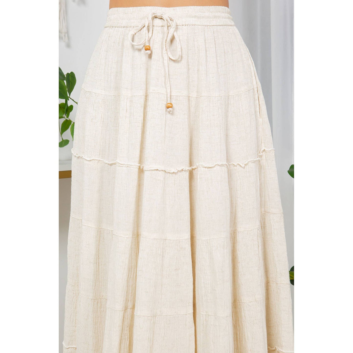 Cream-colored tiered skirt with drawstring waist.