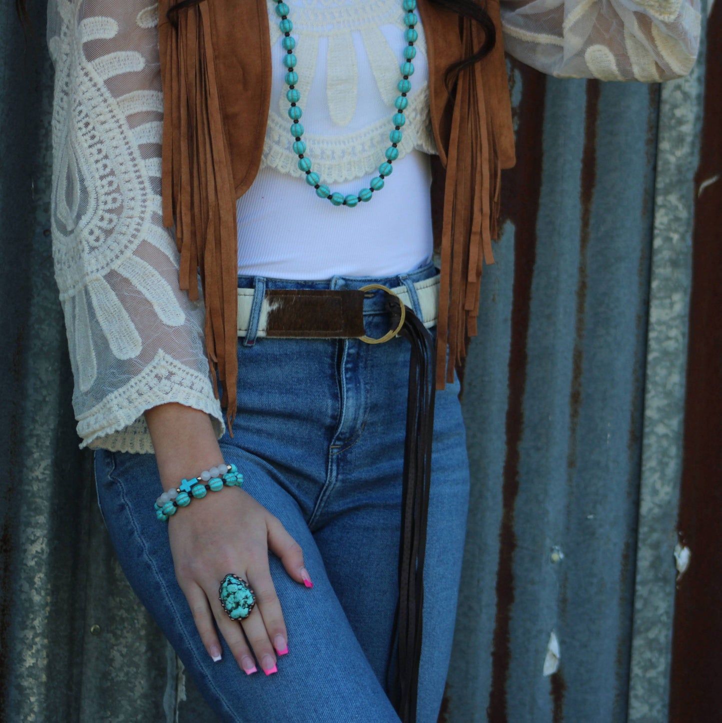 Woman in denim jeans and bohemian accessories.