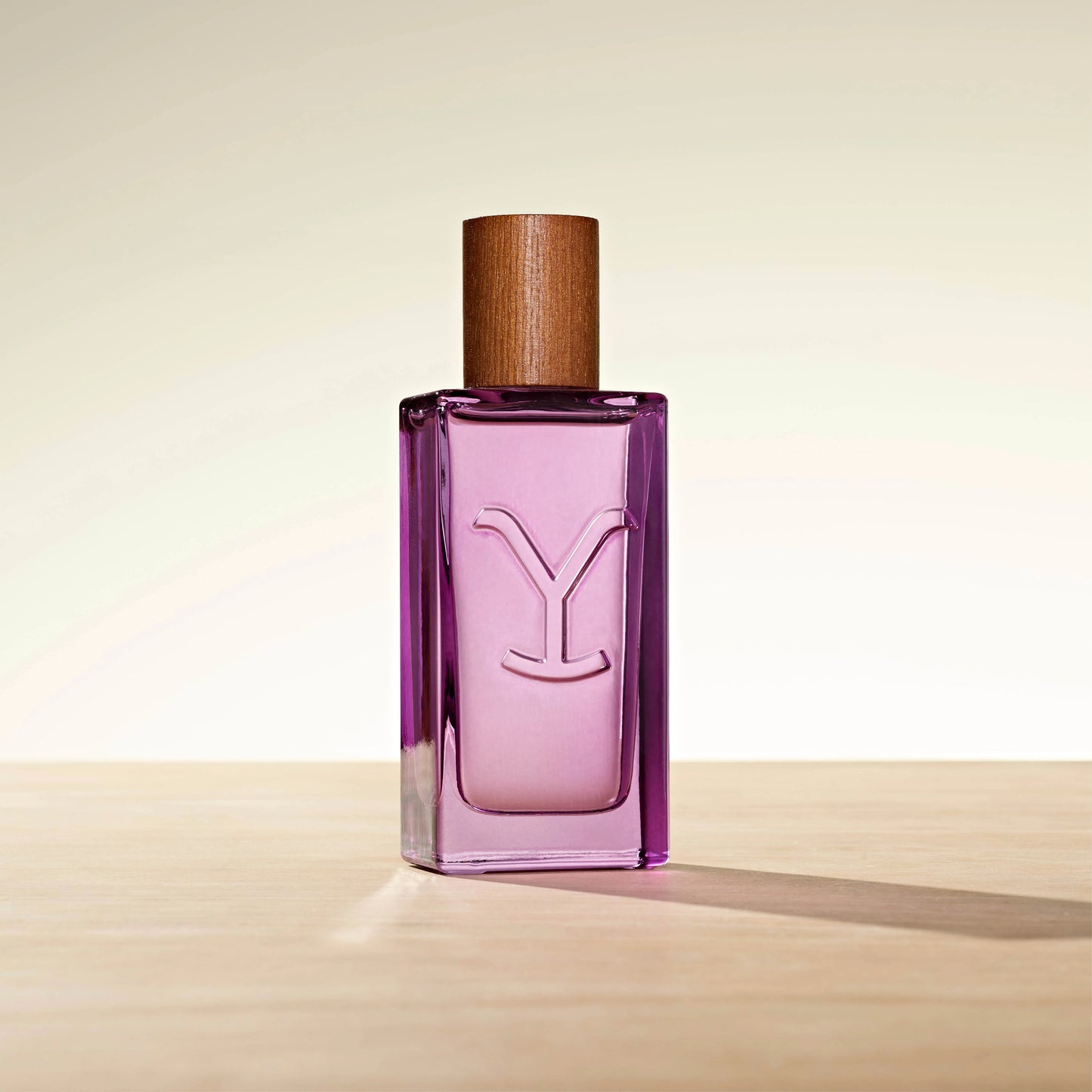 Purple perfume bottle with wooden cap.