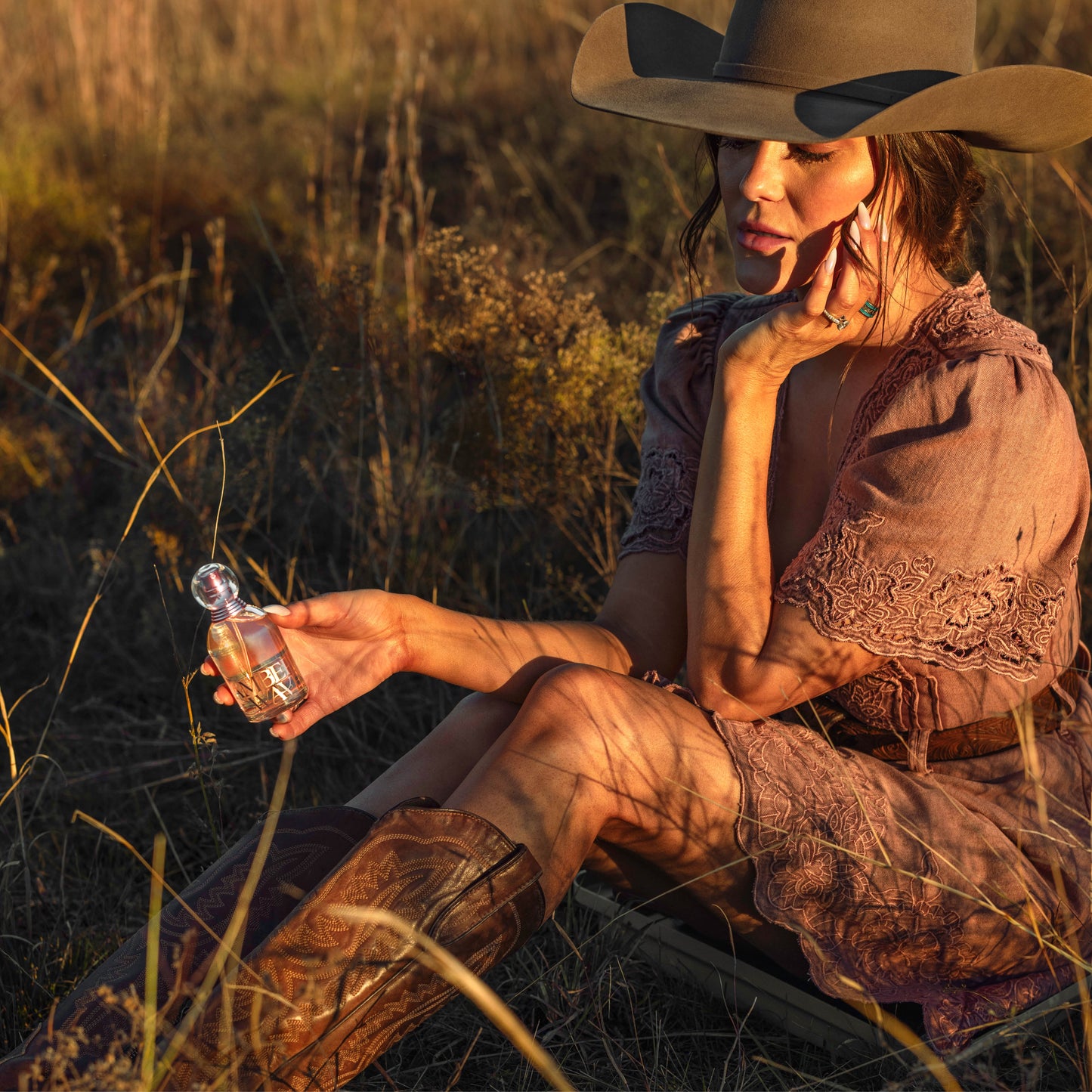 Woman in field with perfume