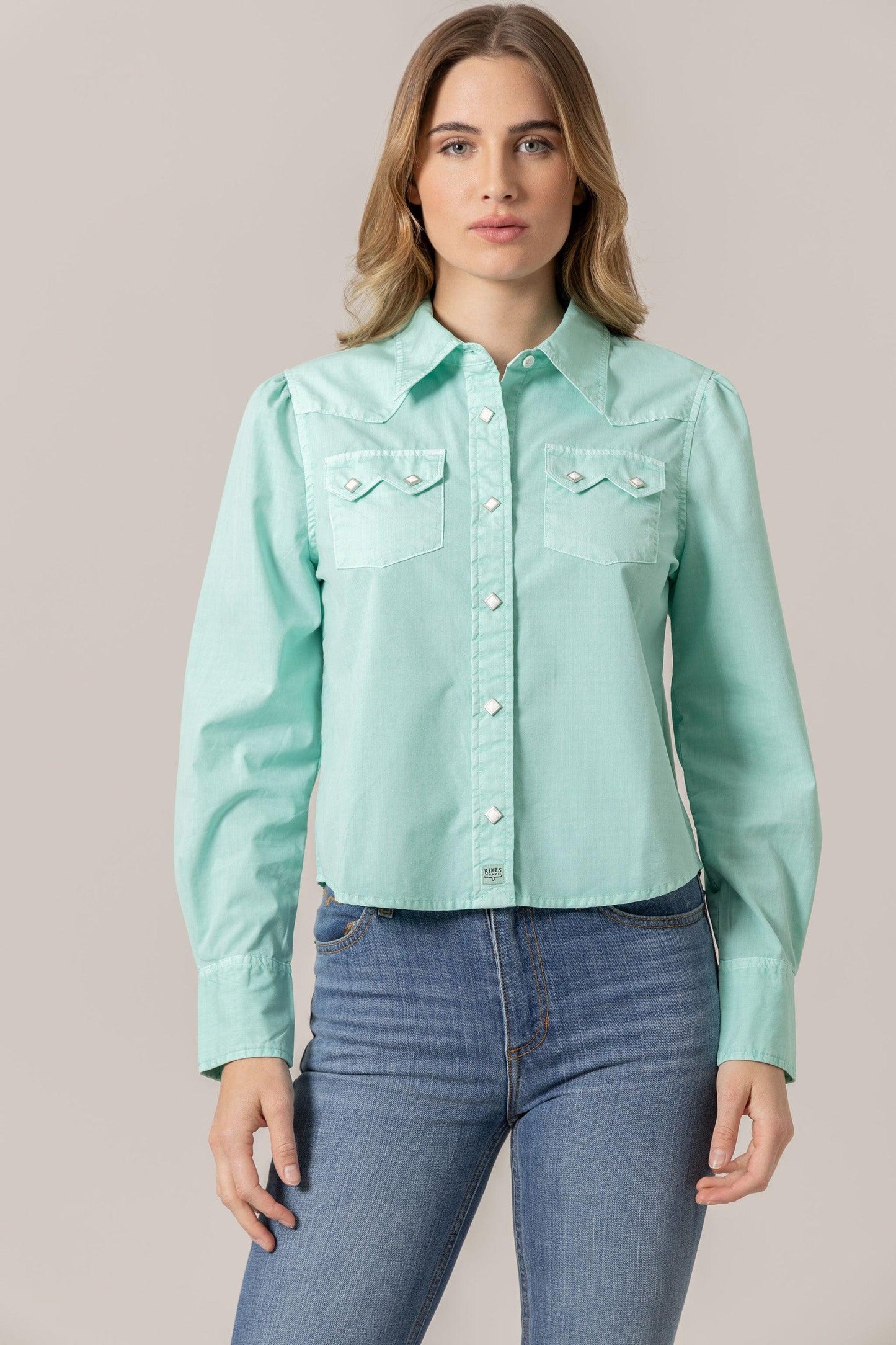 Annie in turquoise button-up crop top