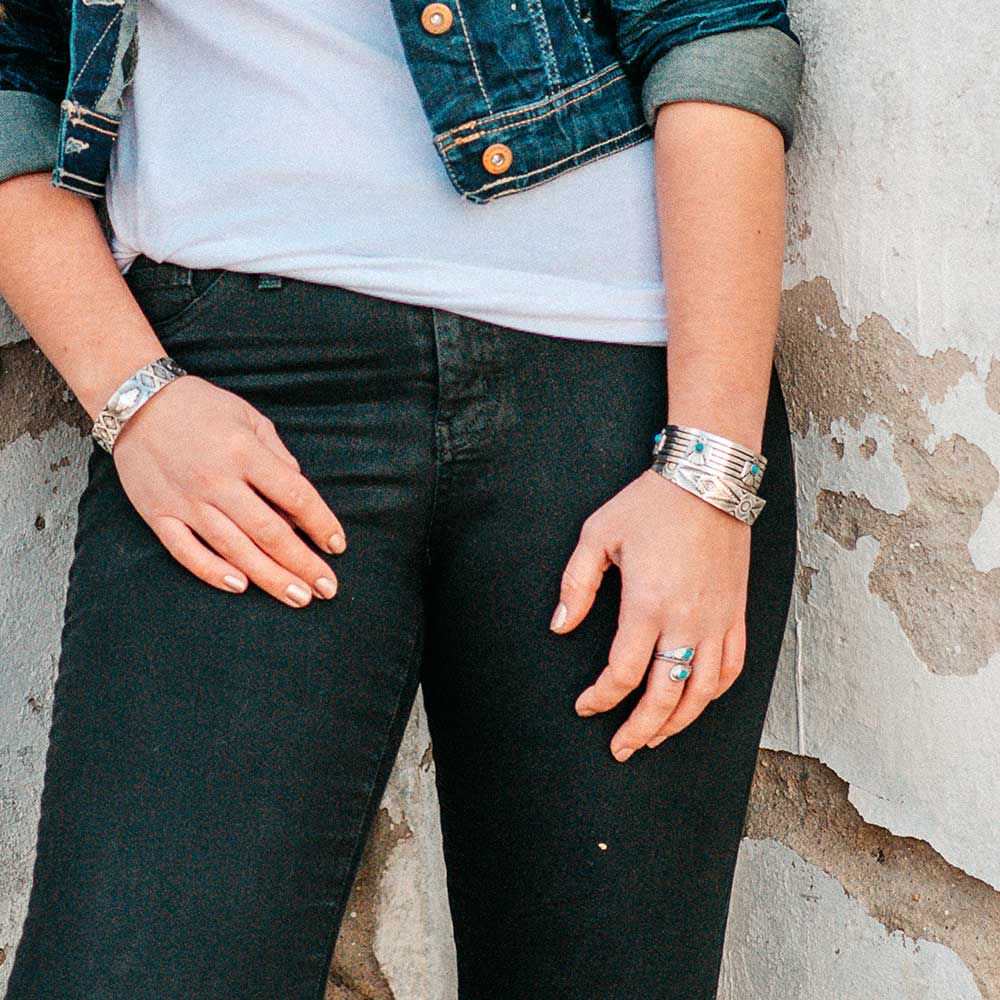 Woman wearing silver bracelets and ring