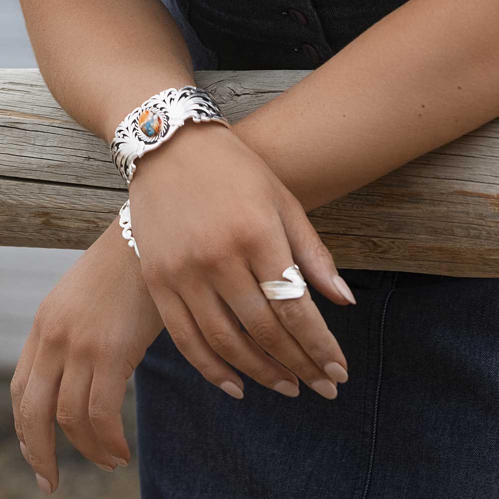 Silver cuff bracelet and ring on woman's hands