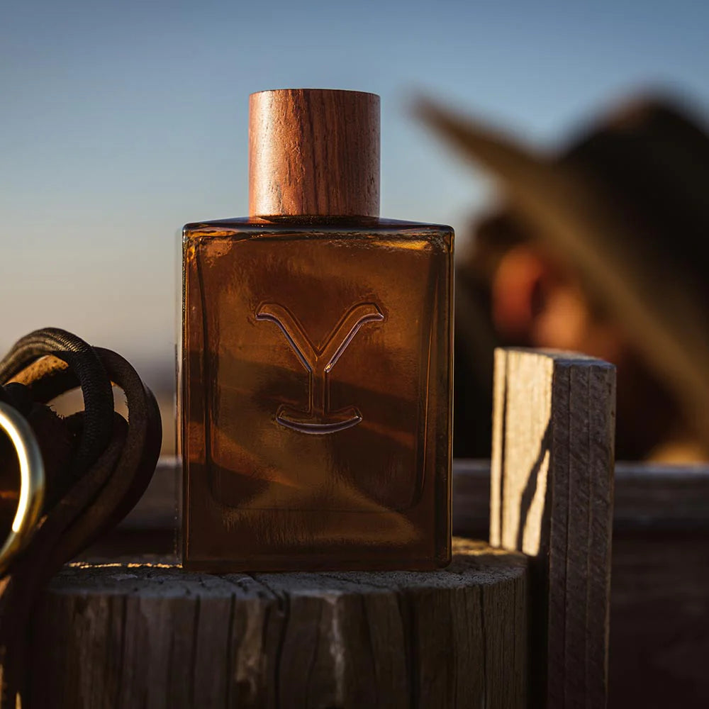 Yellowstone cologne bottle on wooden post