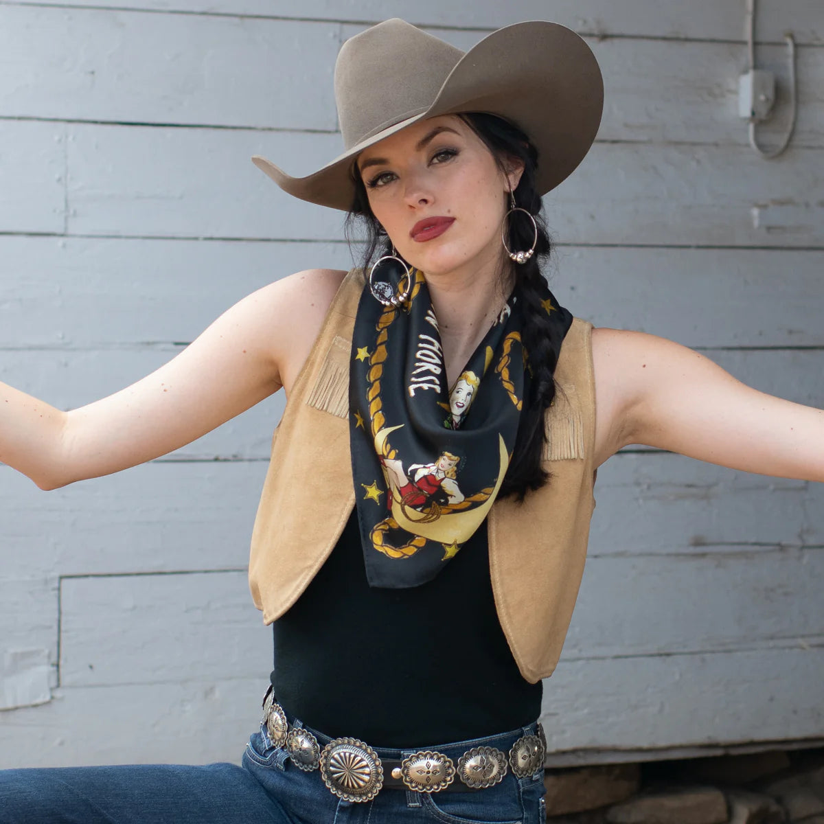 Cowgirl posing in cowboy hat and vest