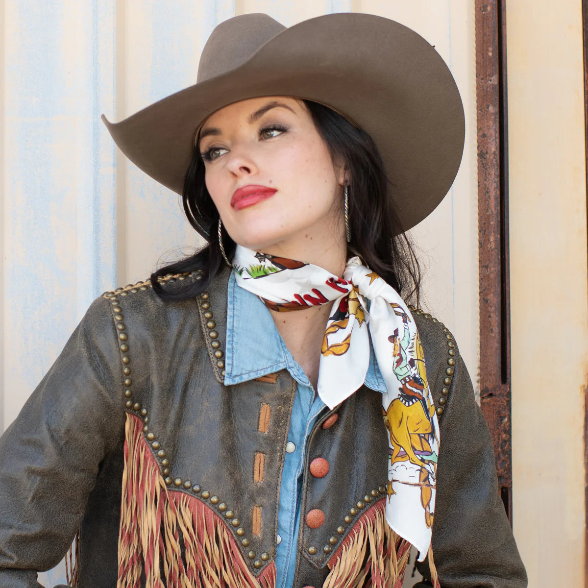Cowgirl in hat and fringed jacket