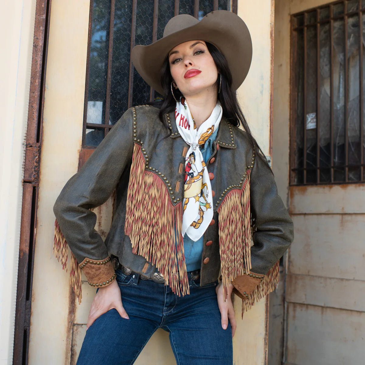 Cowgirl in leather jacket and cowboy hat