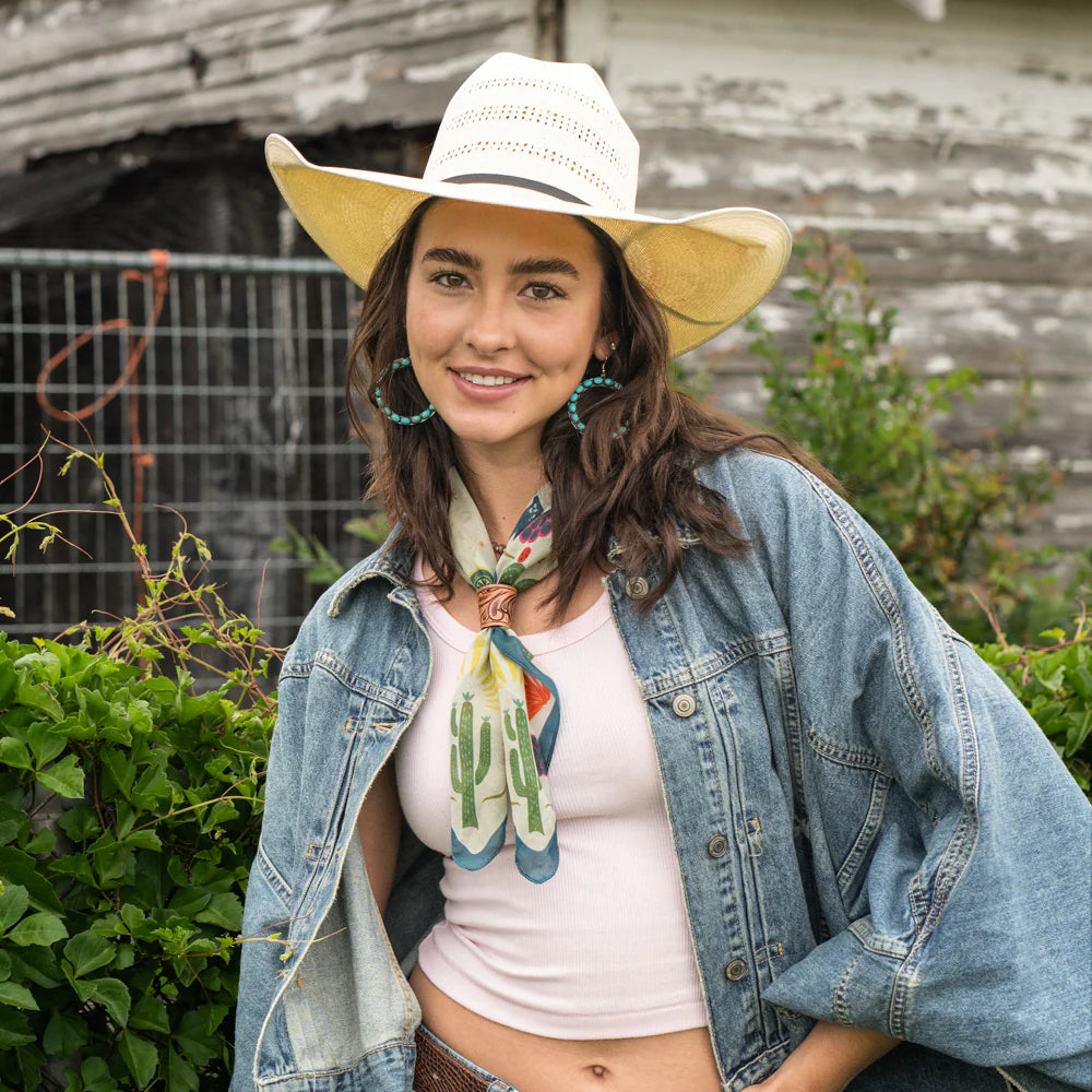 Cowgirl in denim jacket and cowboy hat