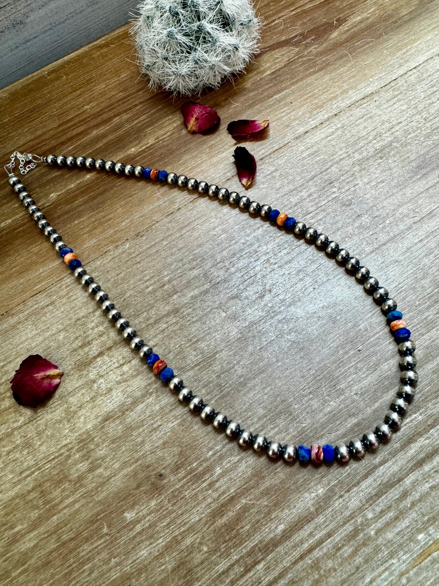 Silver beaded necklace with blue and orange accents