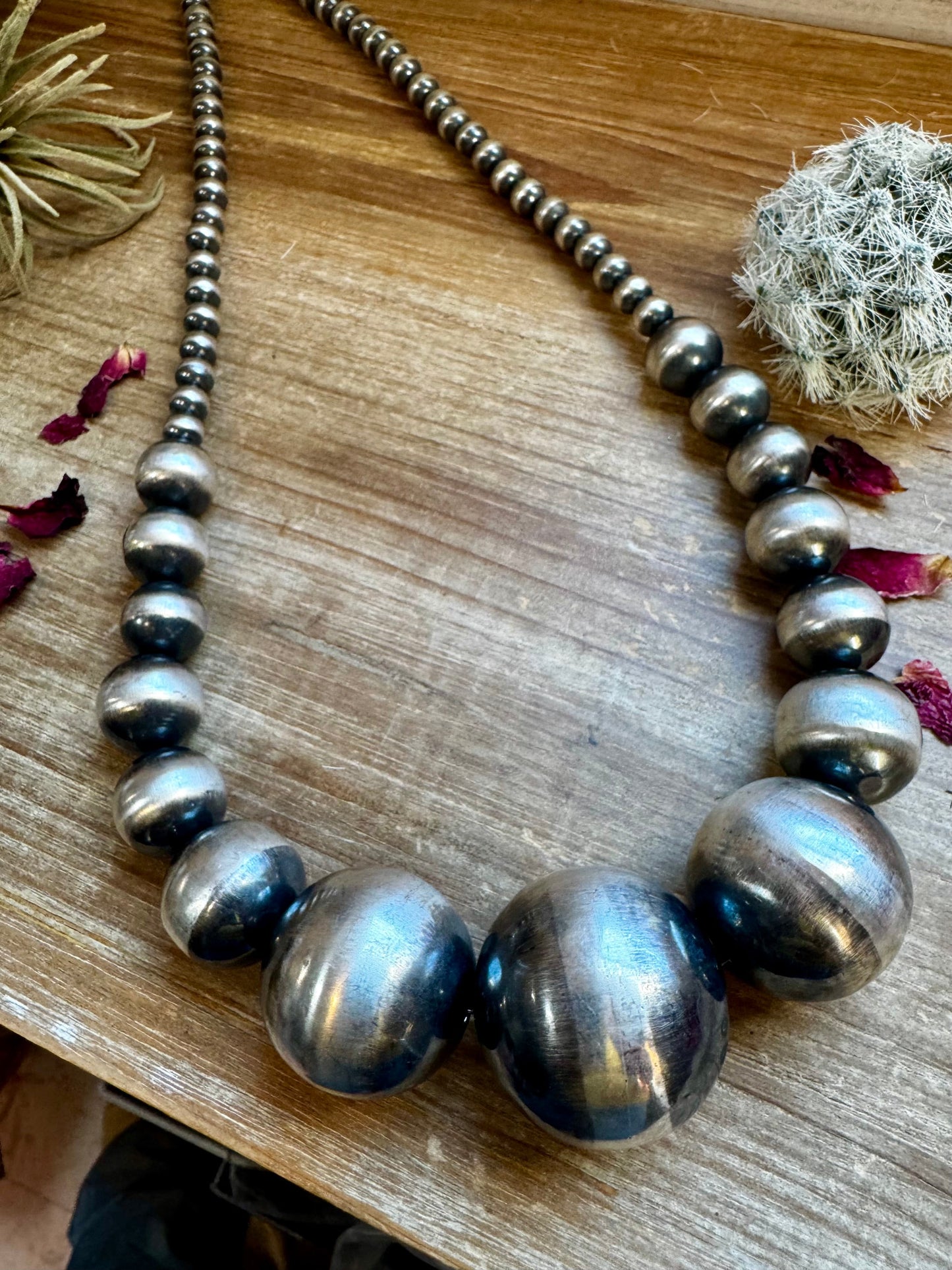 Sterling silver squash blossom necklace on display