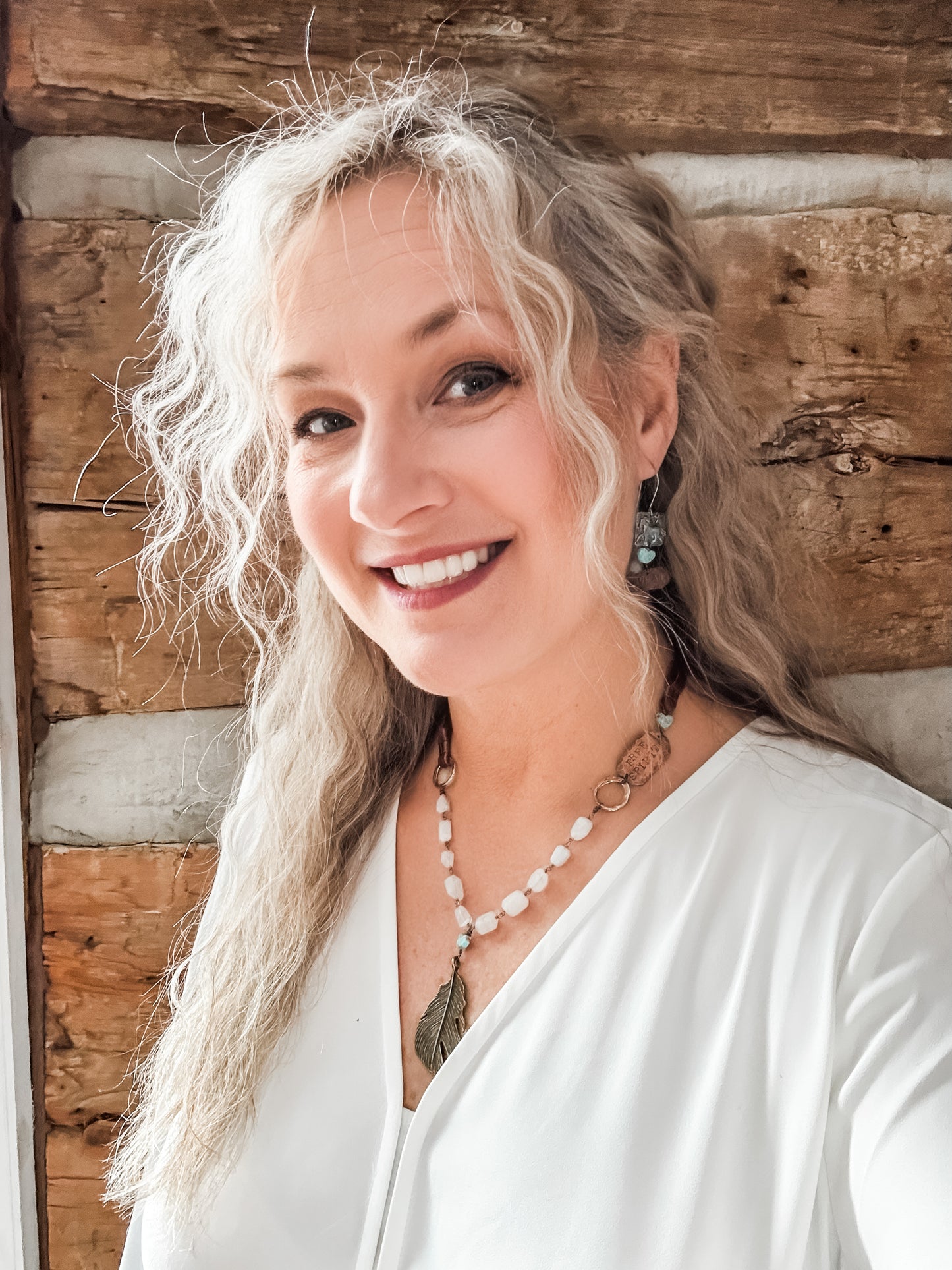 Woman with long wavy hair smiling, Facetune image.