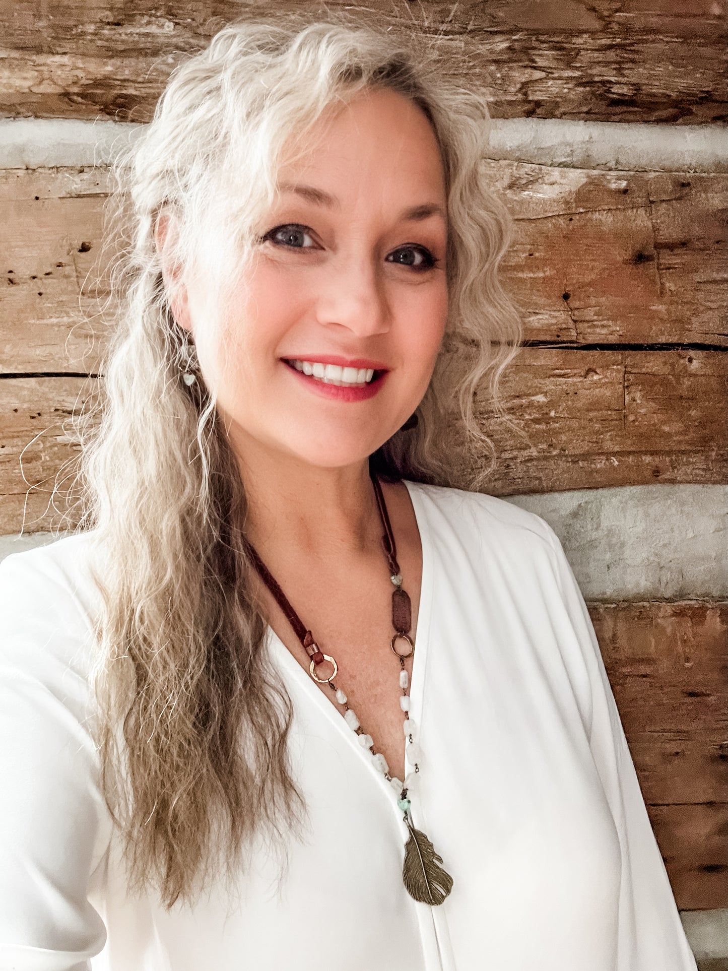 Smiling woman with long gray hair, Facetune photo from 08-01-2024.