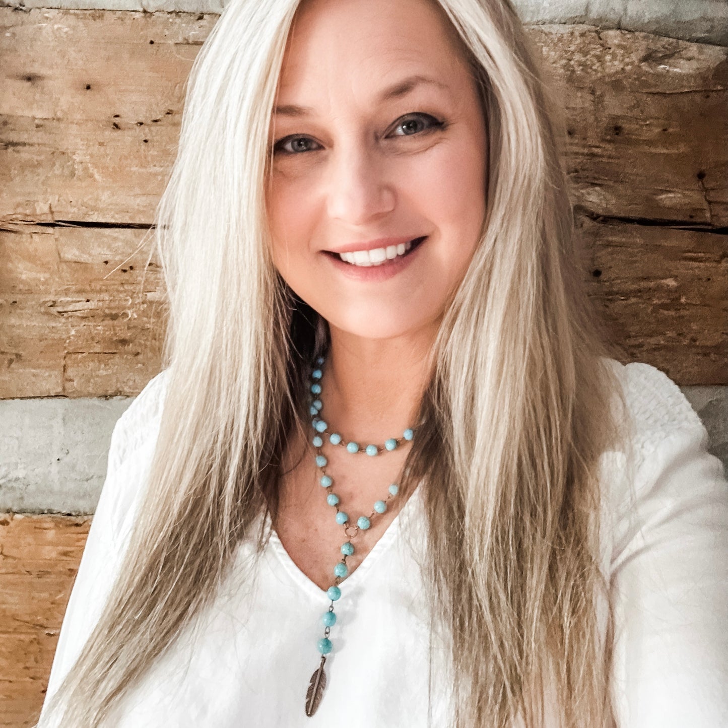 Smiling woman with long blonde hair, Facetune edit.