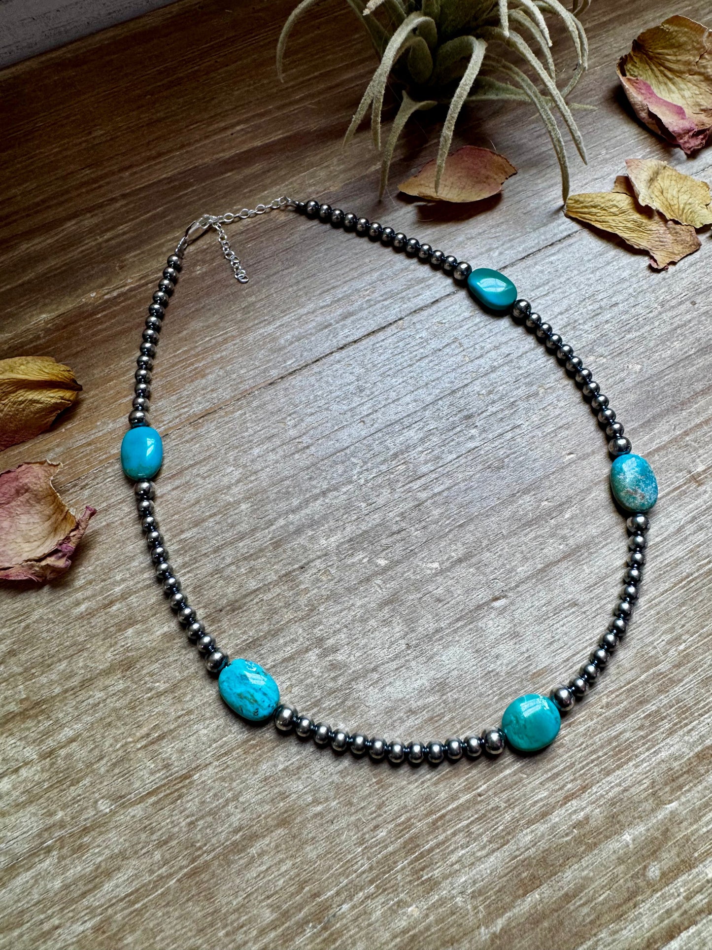 Turquoise bead necklace on wood - FullSizeRender