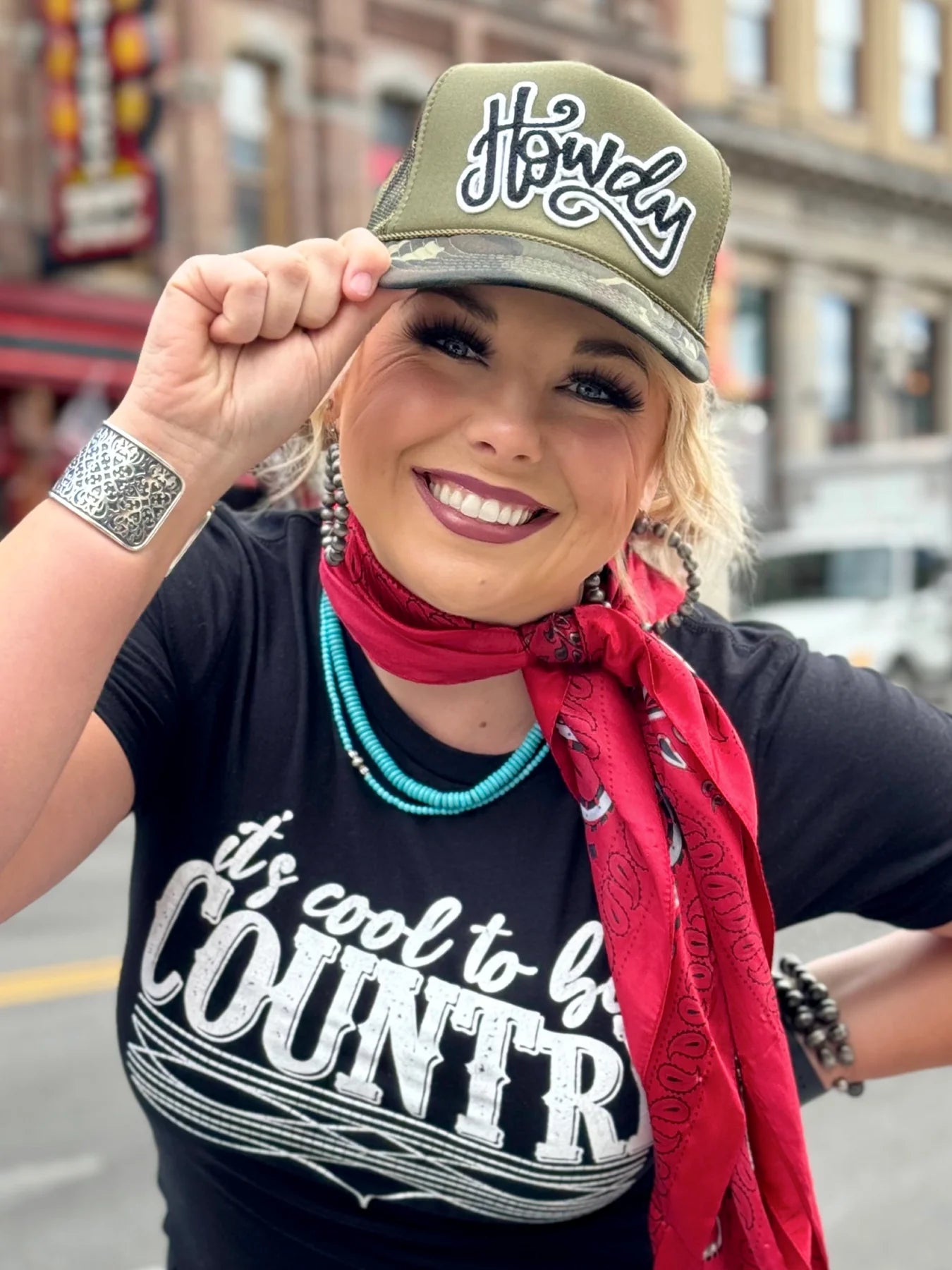 Woman wearing Howdy hat and It's cool to be Country shirt