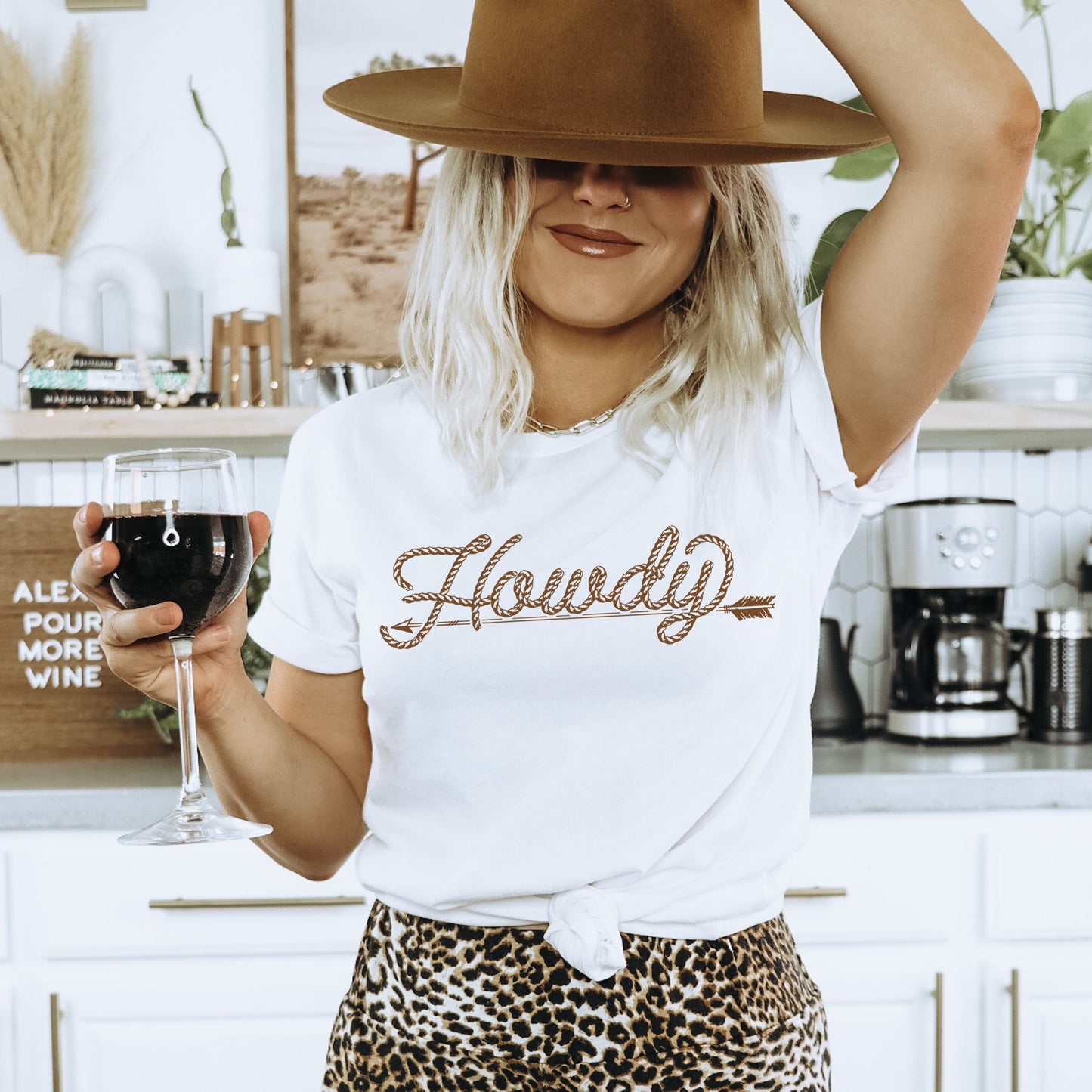 Woman in Howdy t-shirt holding wine