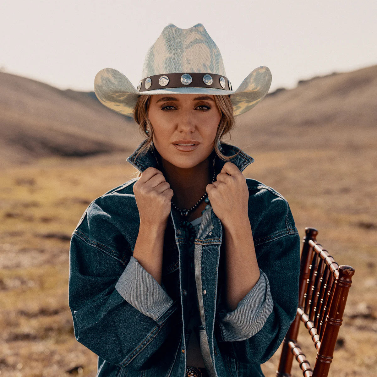Woman in denim jacket & Hang Tight Honey denim hat