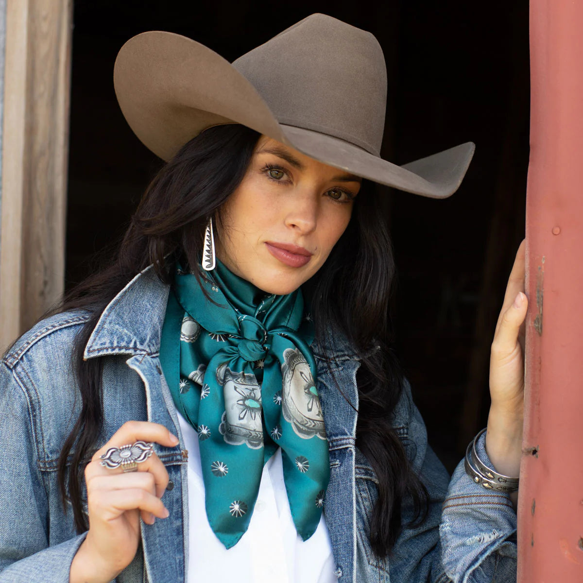 Woman in cowboy hat and silk wild rag scarf