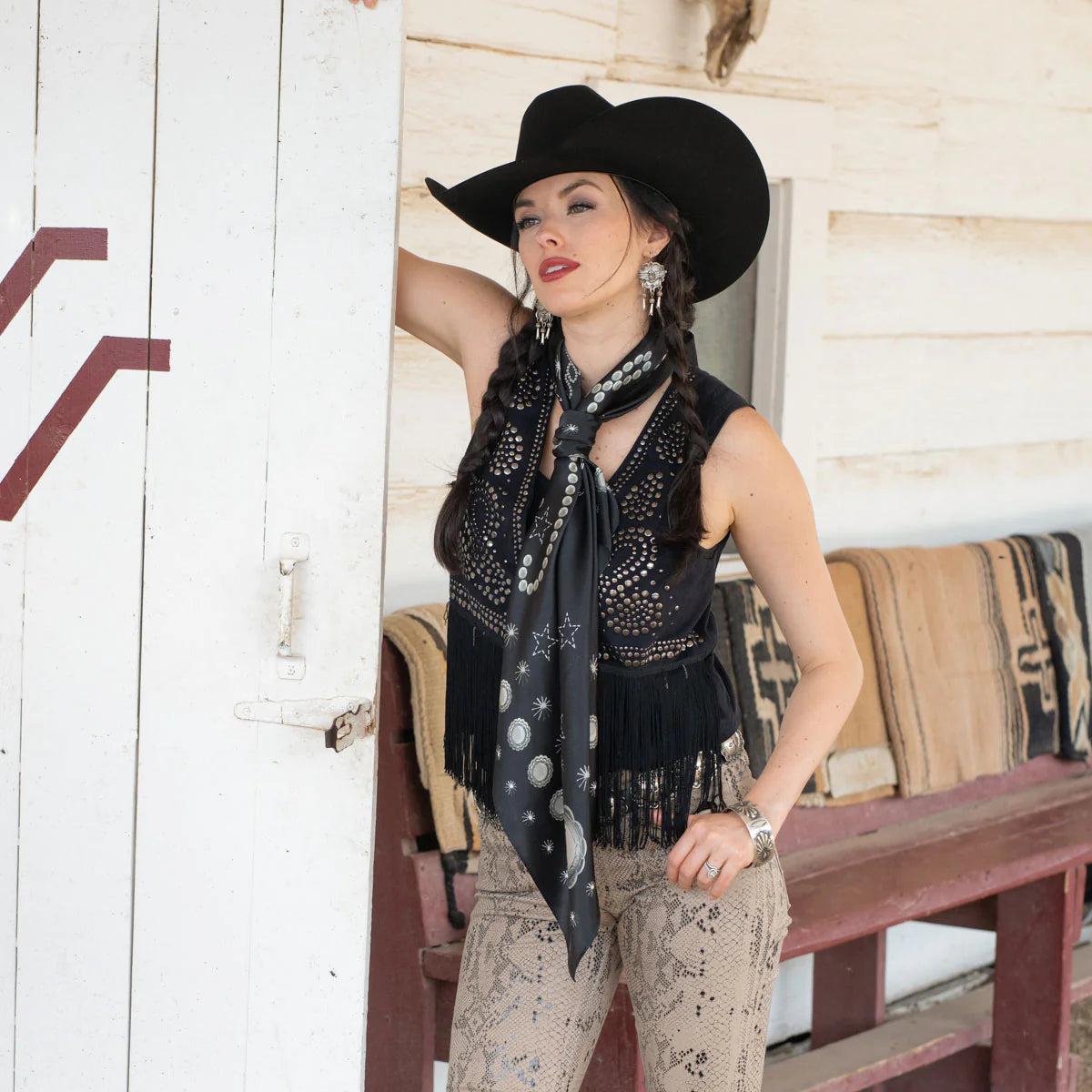 Woman in cowboy hat with black silk scarf and concho