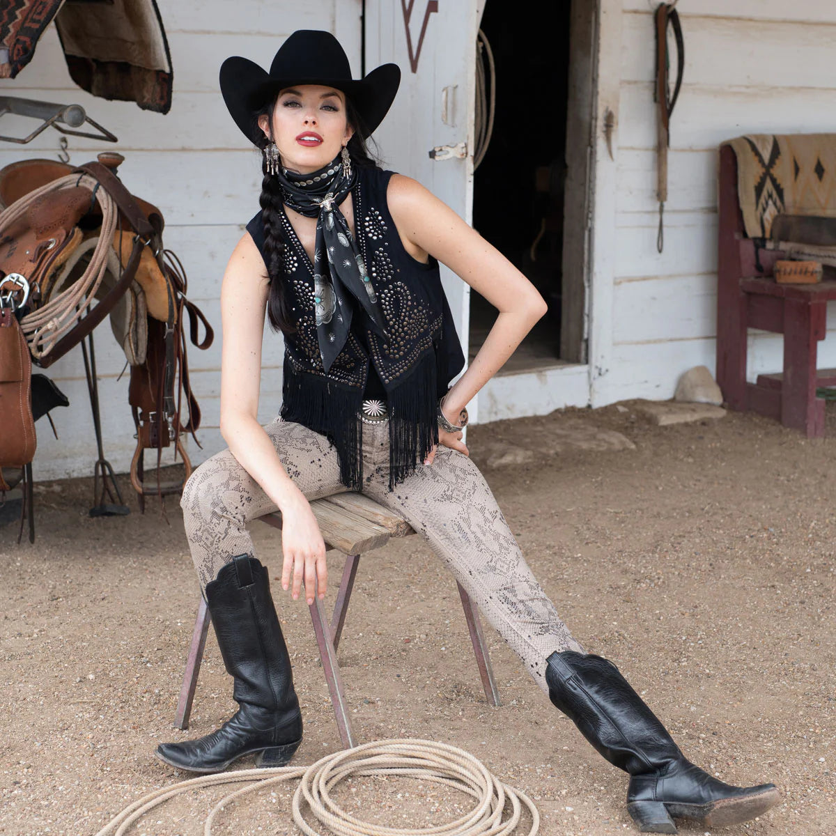 Cowgirl in black vest & silk scarf, concho detail