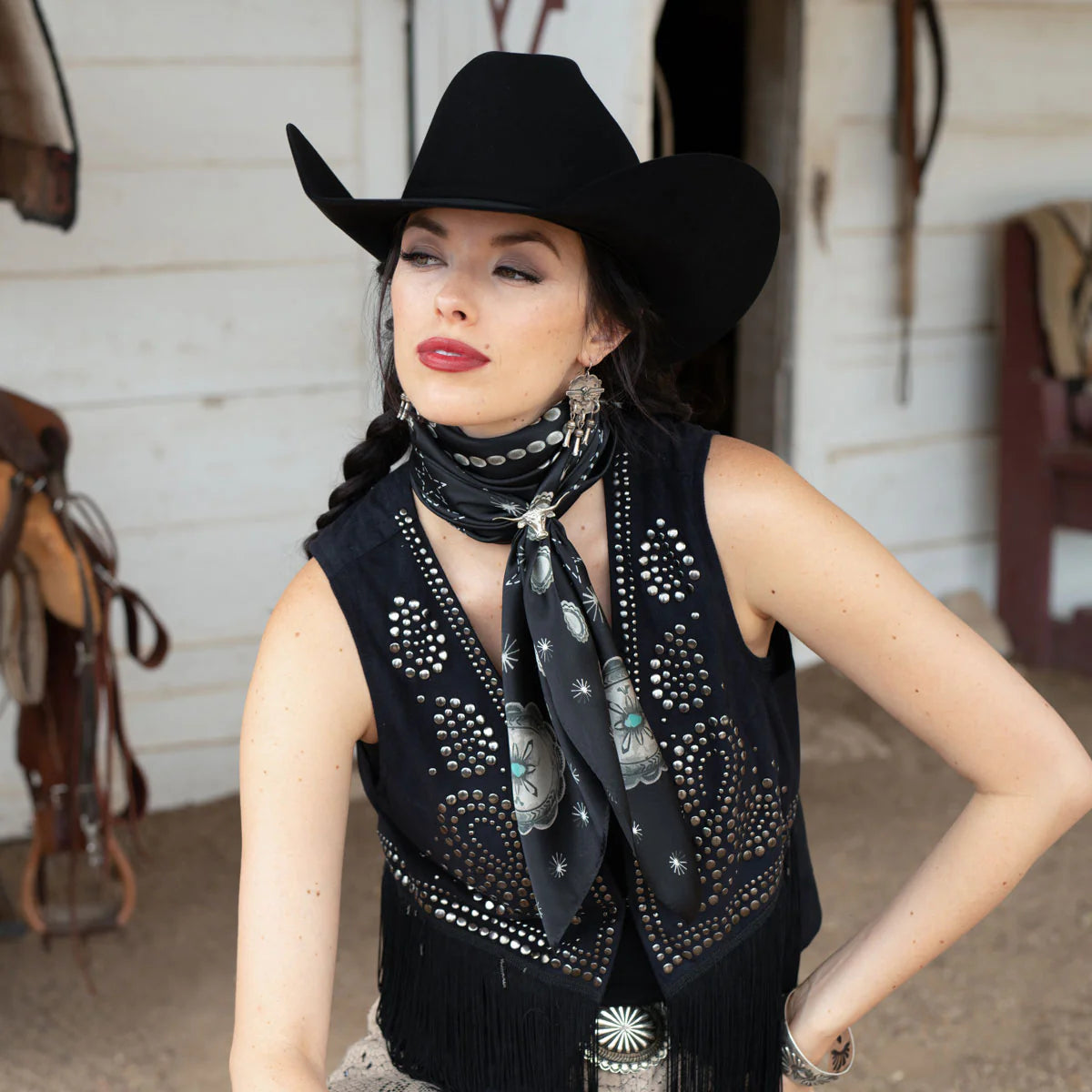 Cowgirl in black silk wild rag scarf and concho vest.