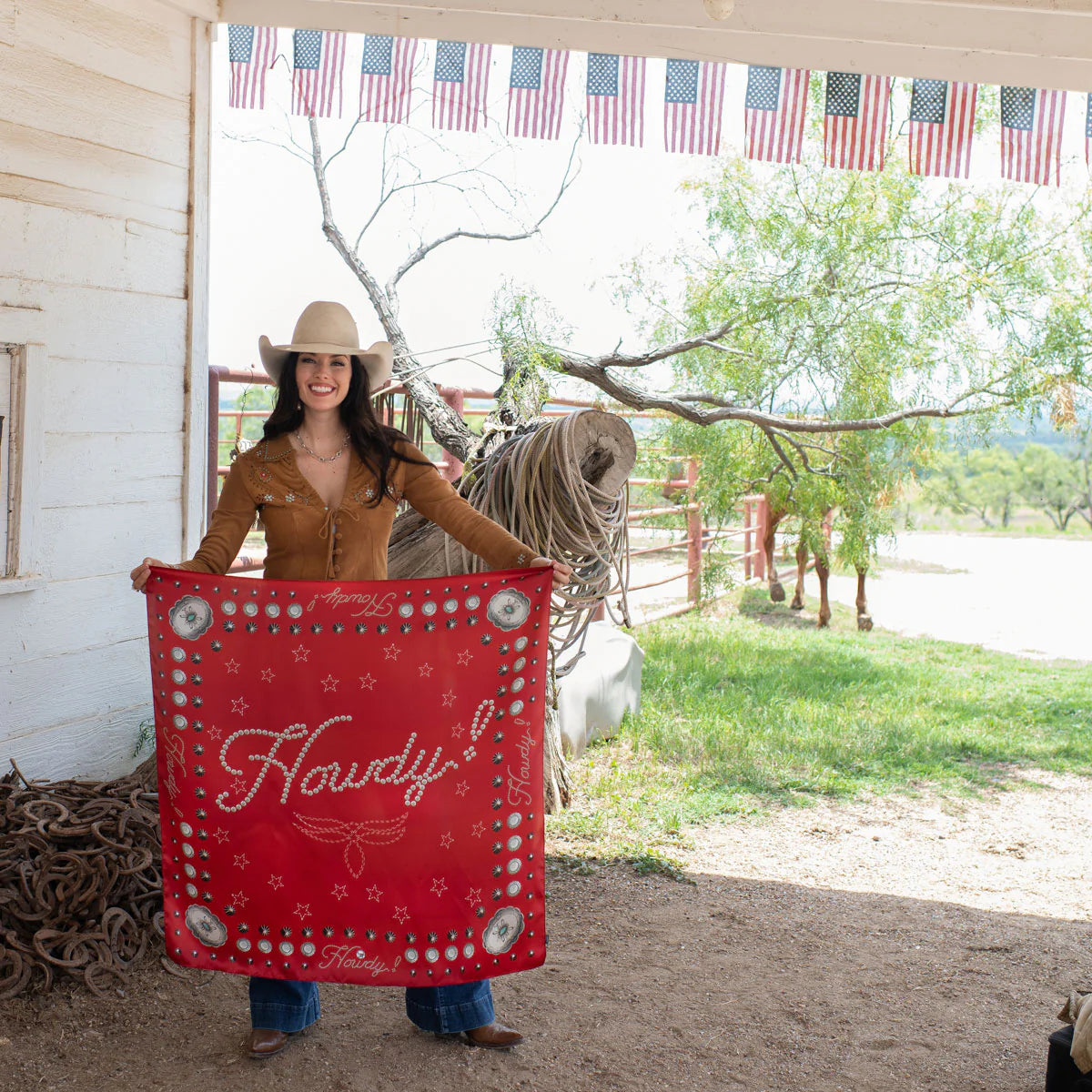Cowgirl holding red Howdy silk scarf