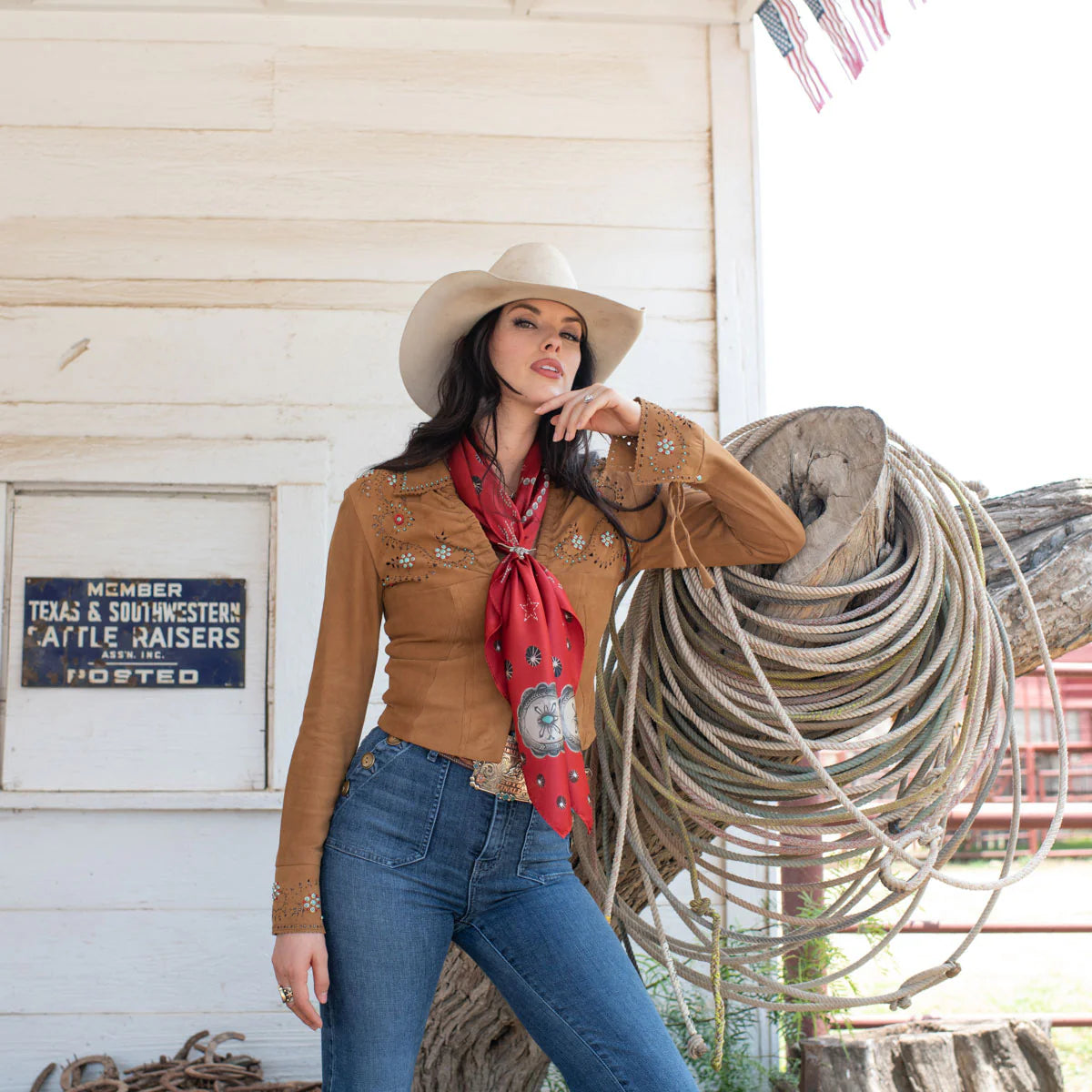 Cowgirl in red silk wild rag scarf and cowboy hat.