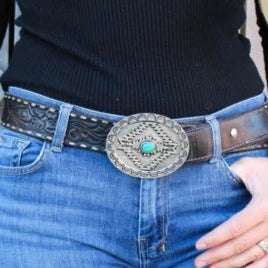 Cowboy belt buckle on jeans