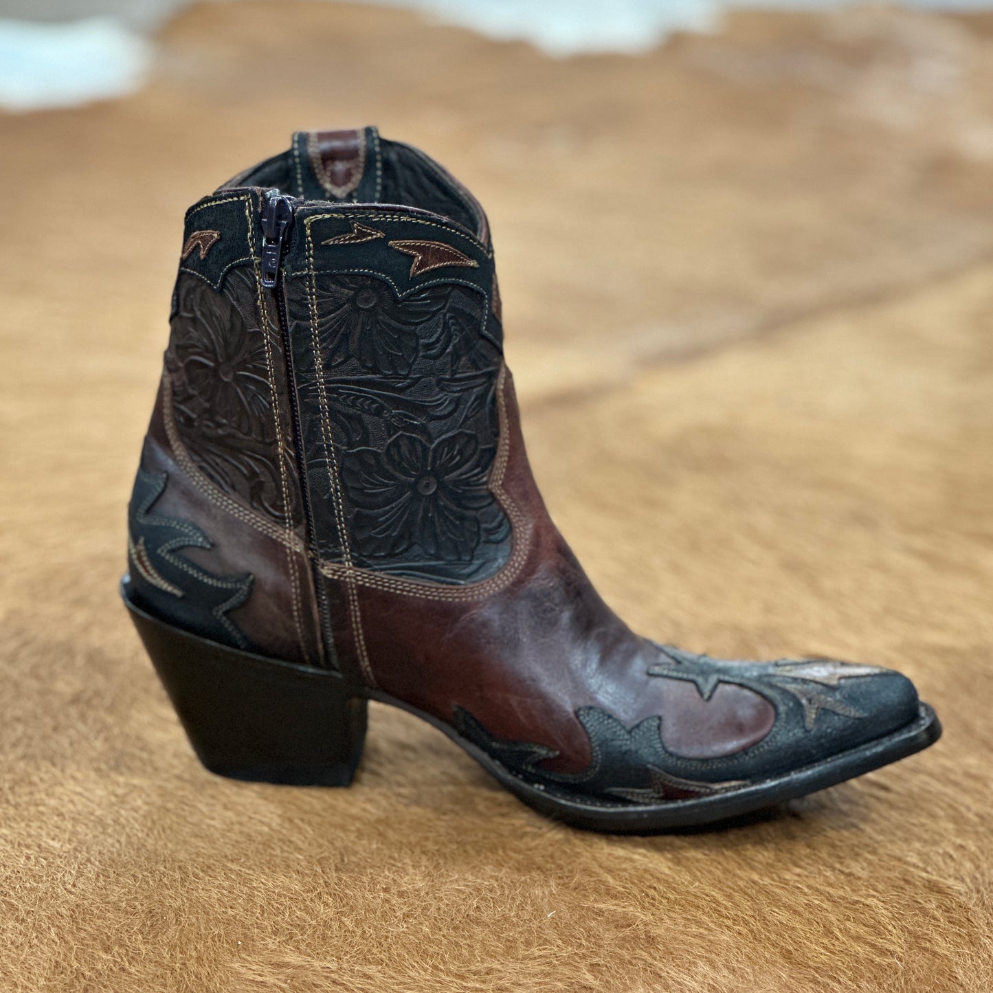 Brown and black leather cowboy boot.