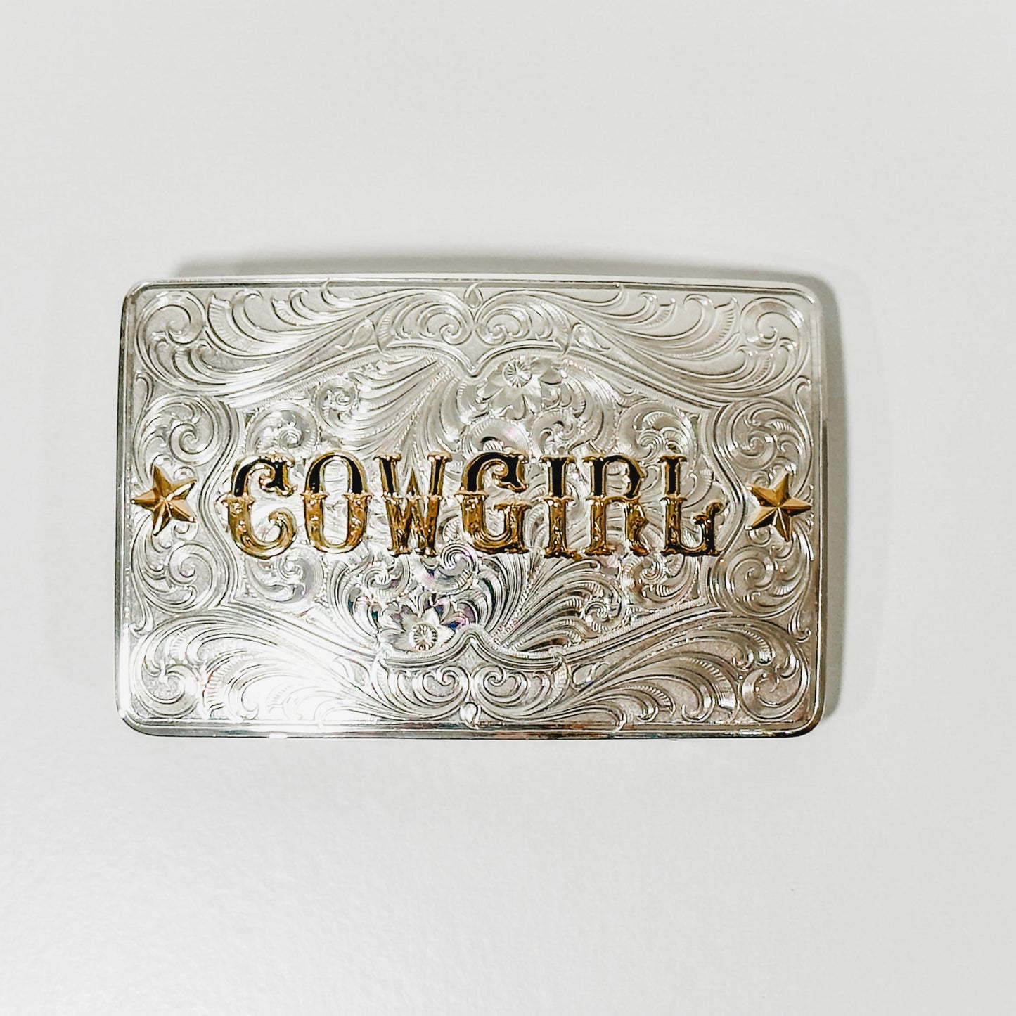 Silver belt buckle with COWGIRL text.