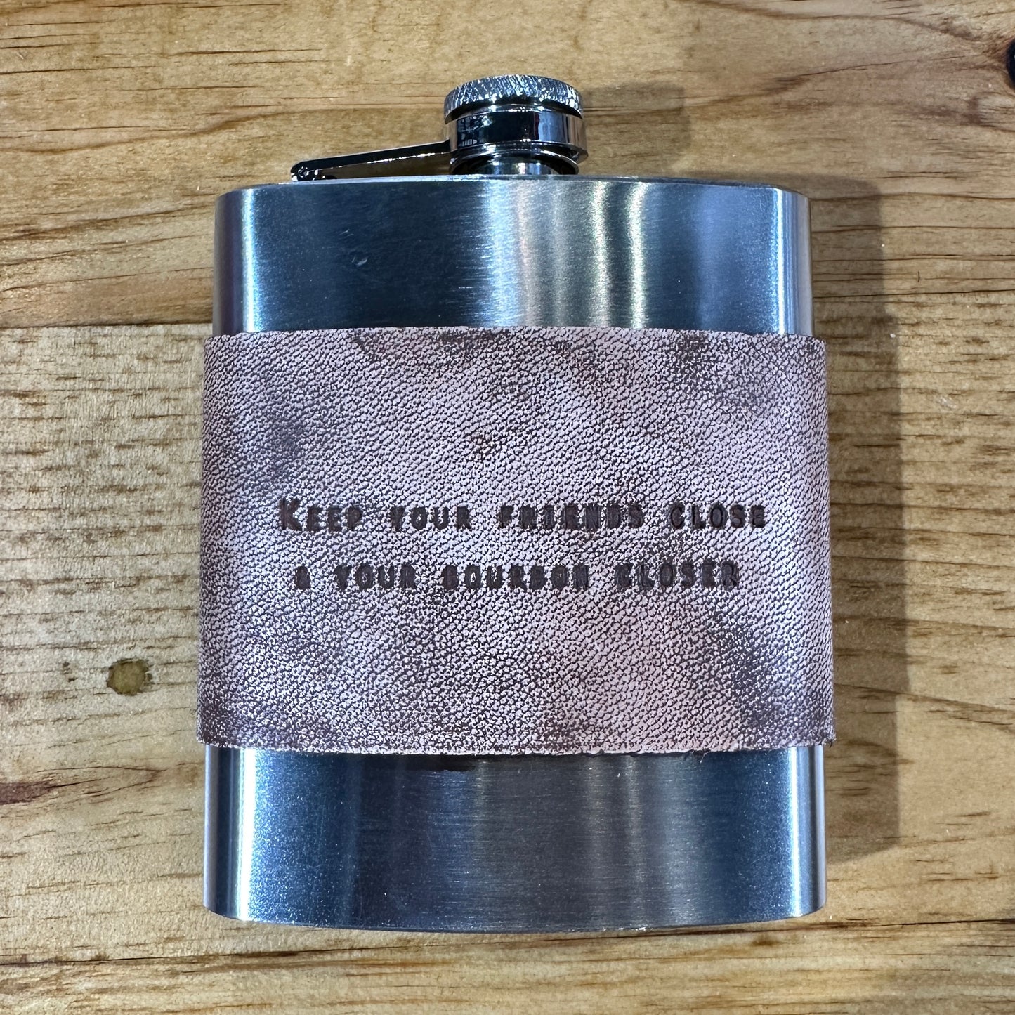 Stainless steel flask with leather band.