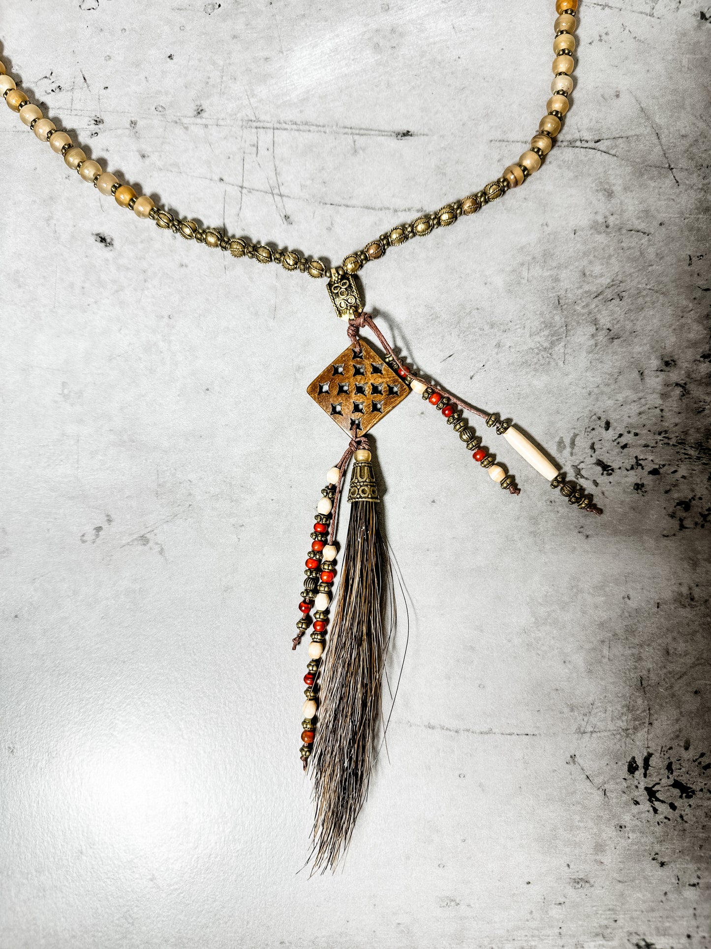 Necklace with beaded chain and pendant.