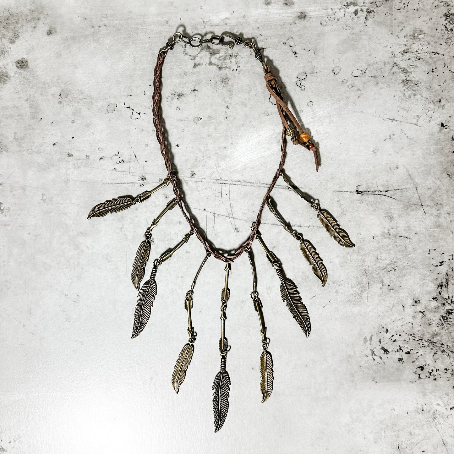 Necklace with metal feathers.