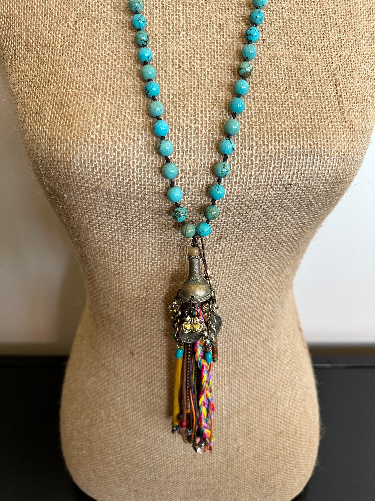 Turquoise beaded necklace with tassel on display (IMG_28482)