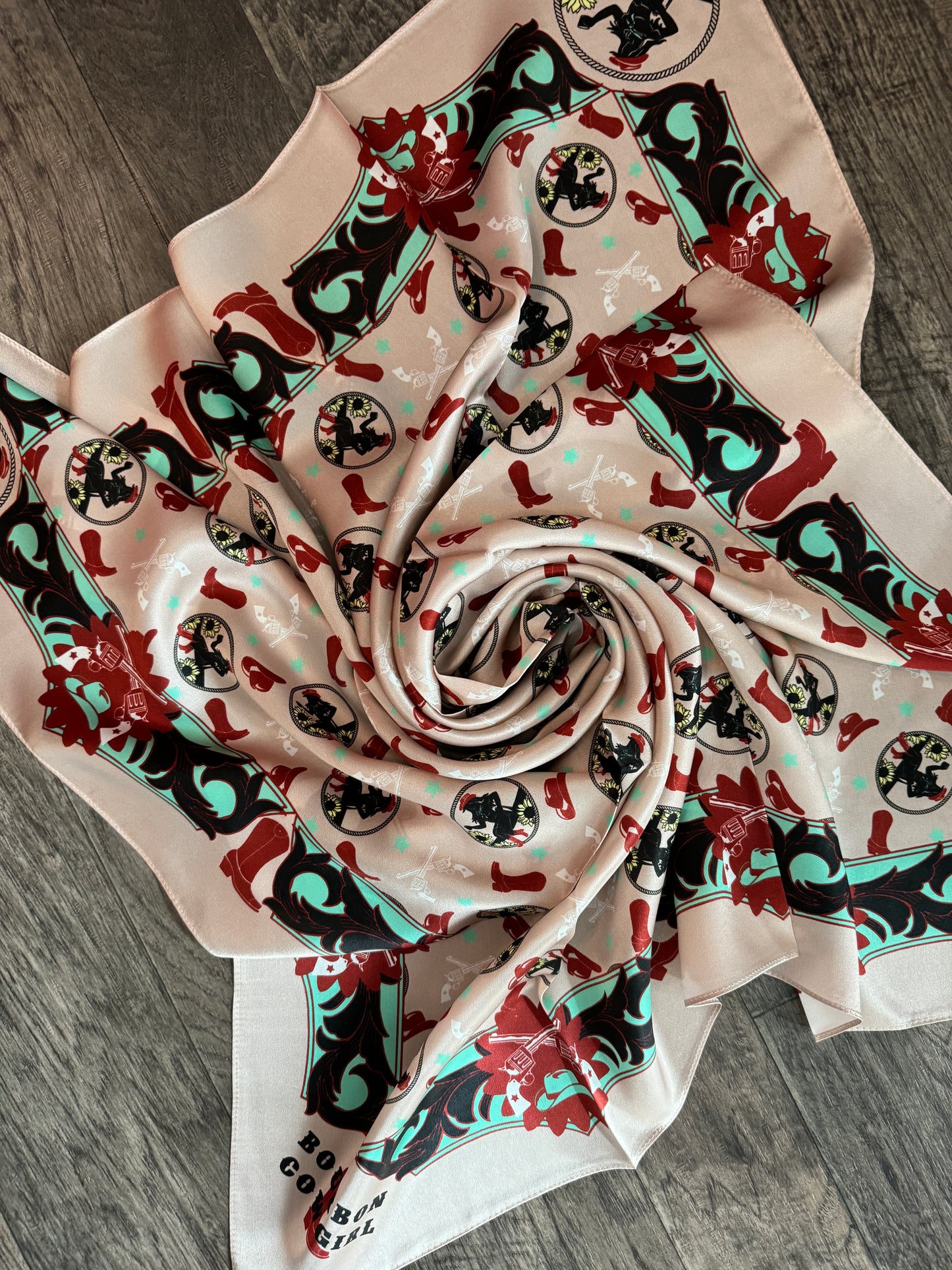Swirled beige scarf with western print.