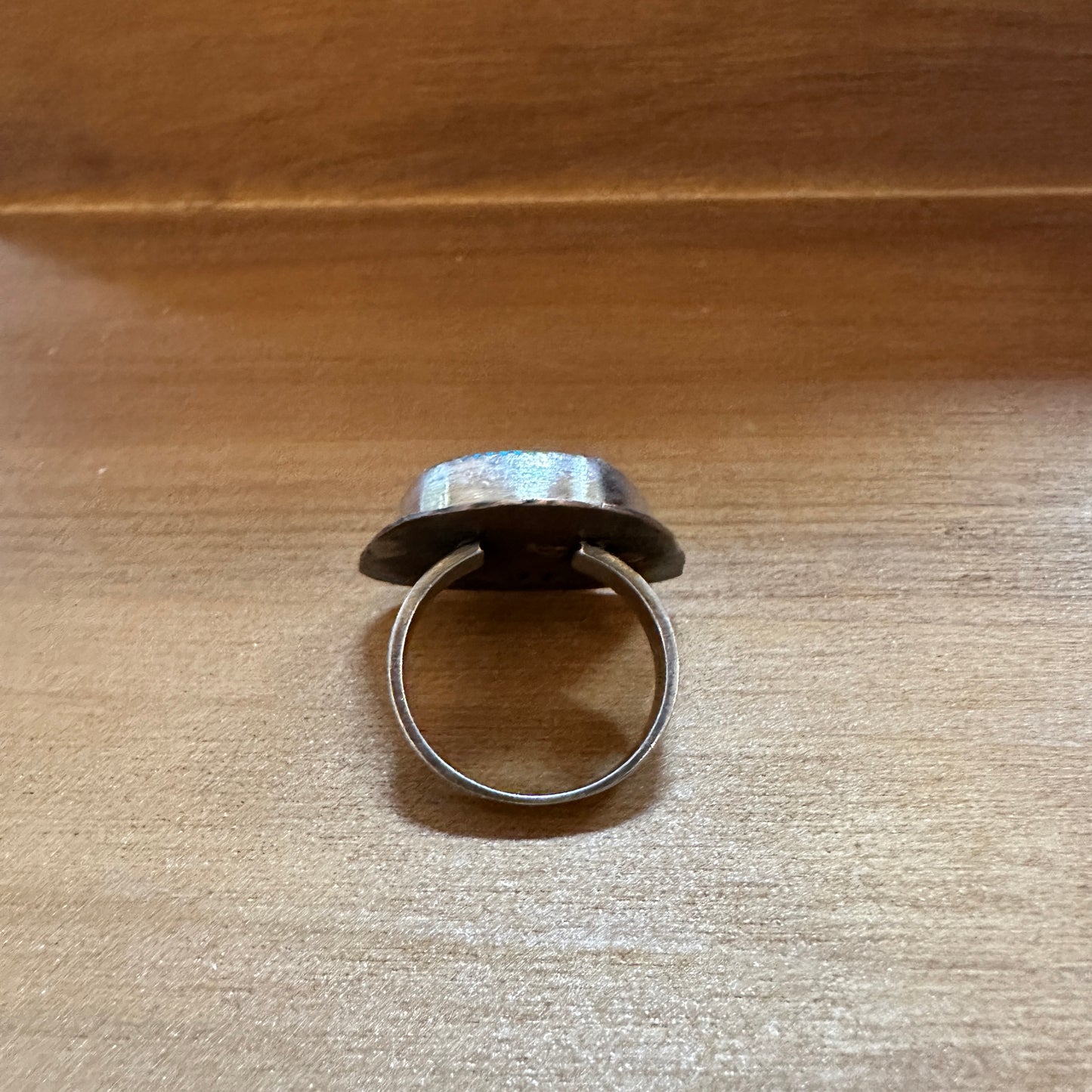 Silver ring with a large, round gemstone.