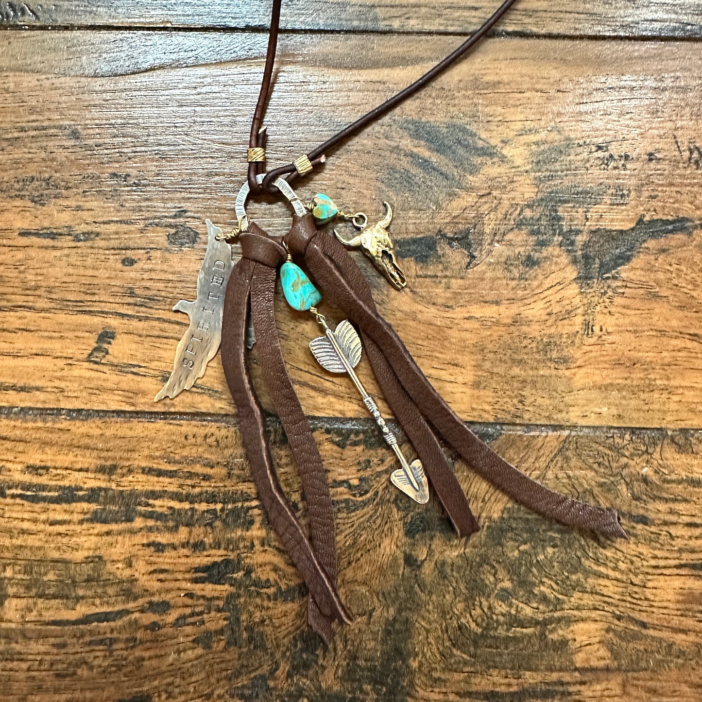 Leather necklace with charms.