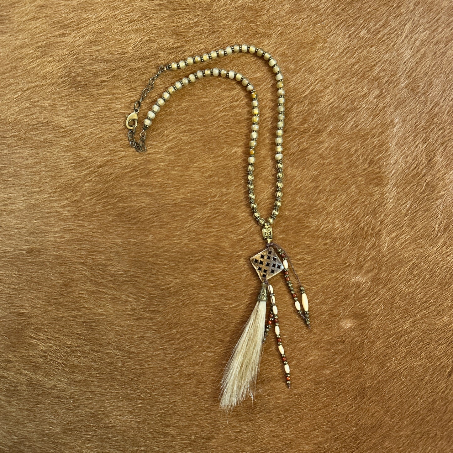 Beaded necklace with pendant and tassels.