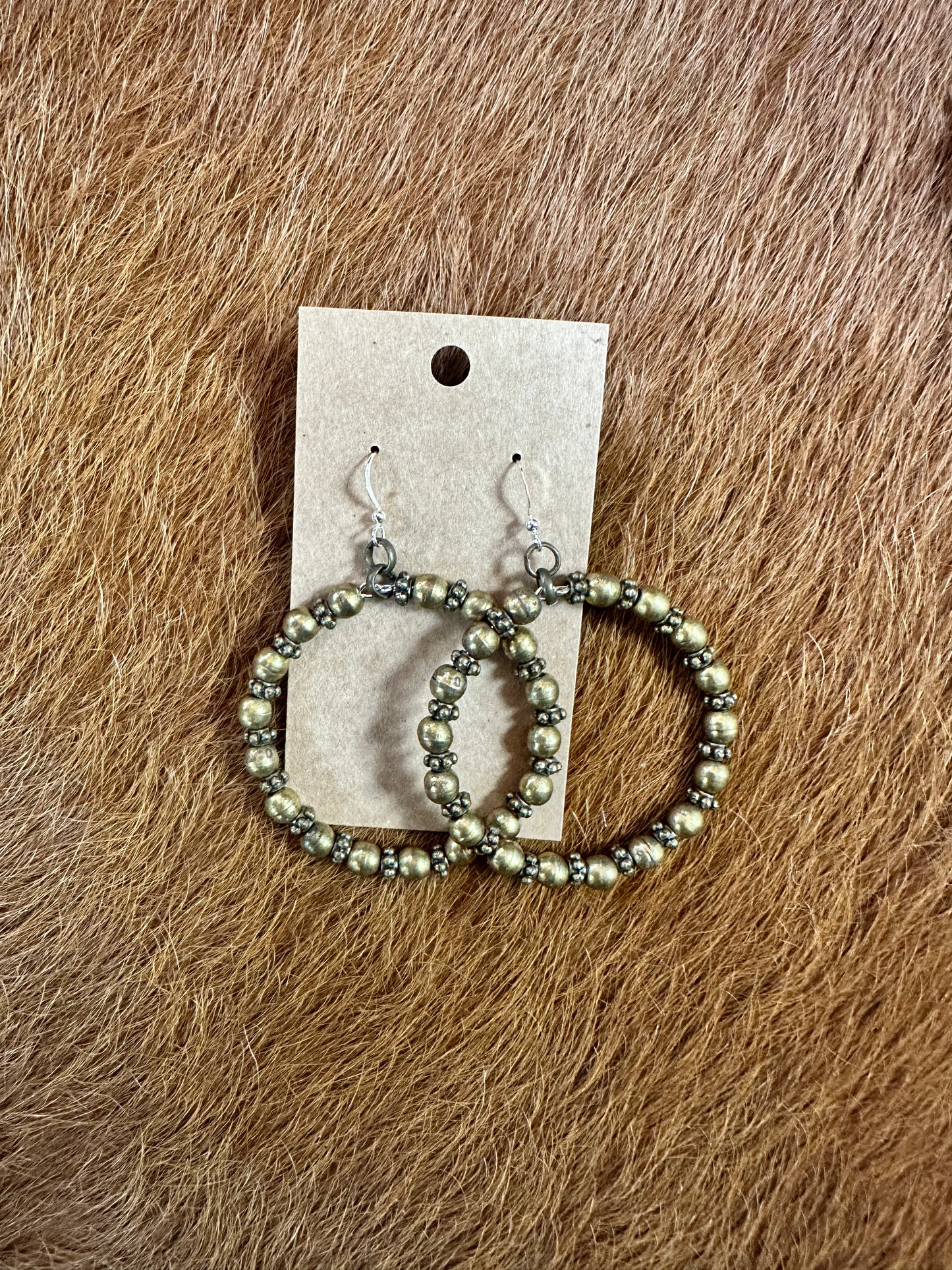 Hoop earrings with small beads on display card.