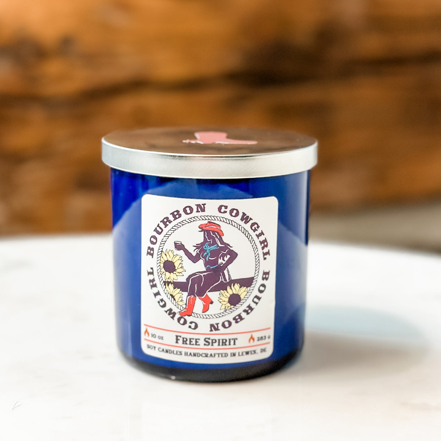 Blue candle with Bourbon Cowgirl label.