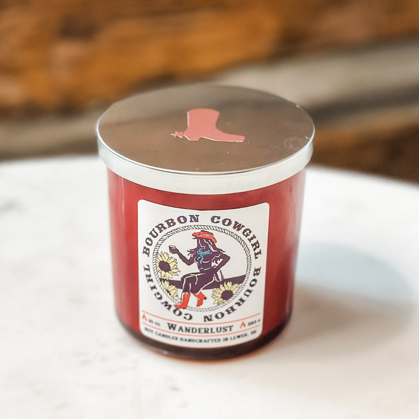 Red candle with Bourbon Cowgirl label.