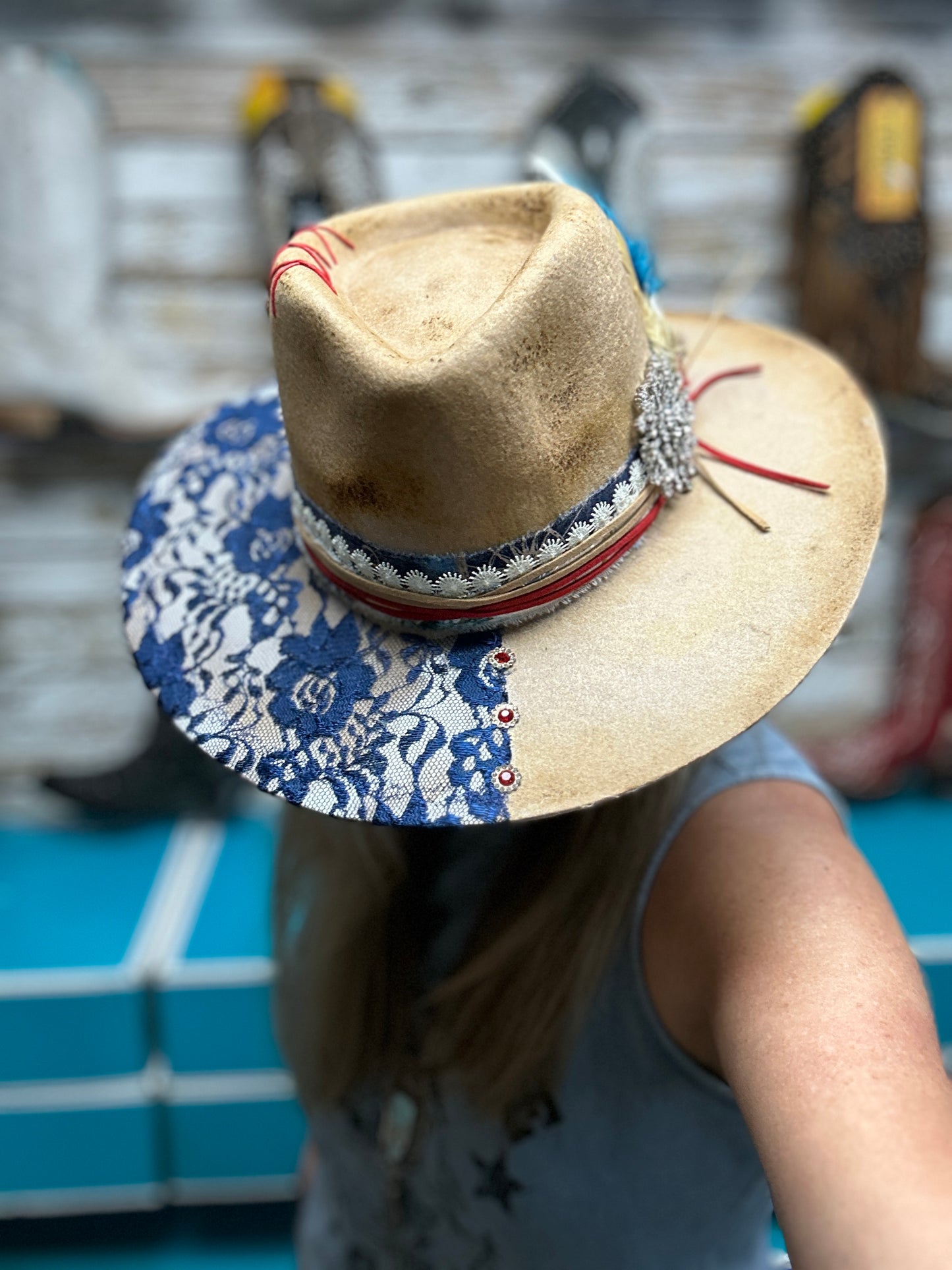 Cowboy hat with blue floral brim, on a person.