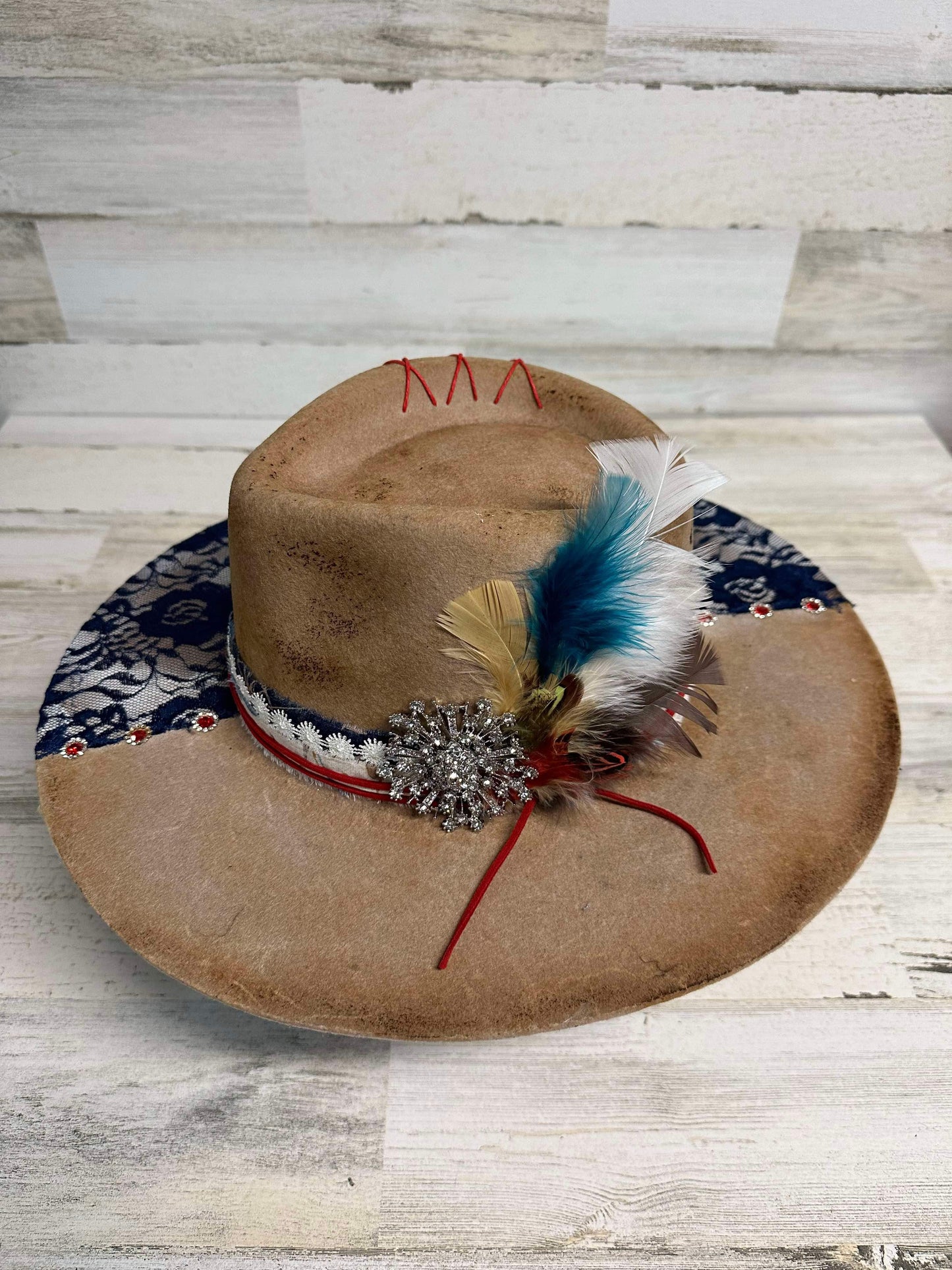 Cowboy hat with feathers and embellishments.