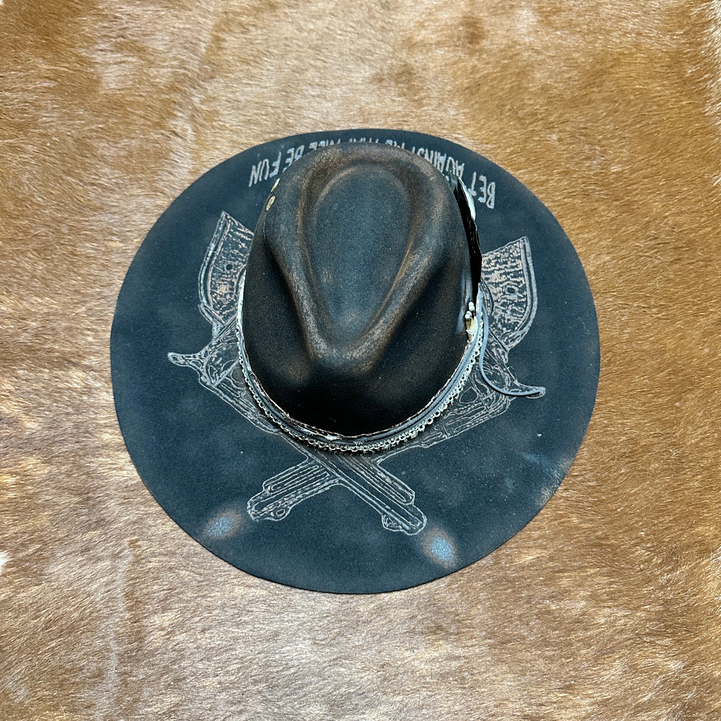 Dark fedora hat on a brown surface.