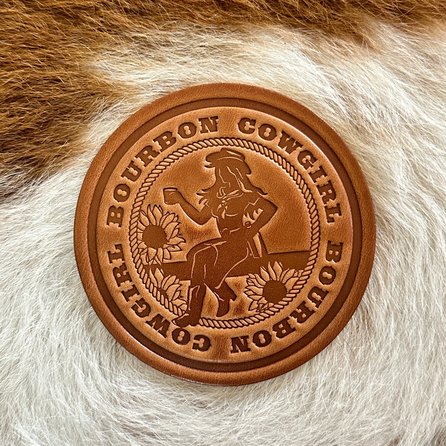 Brown leather coaster with Bourbon Cowgirl design.