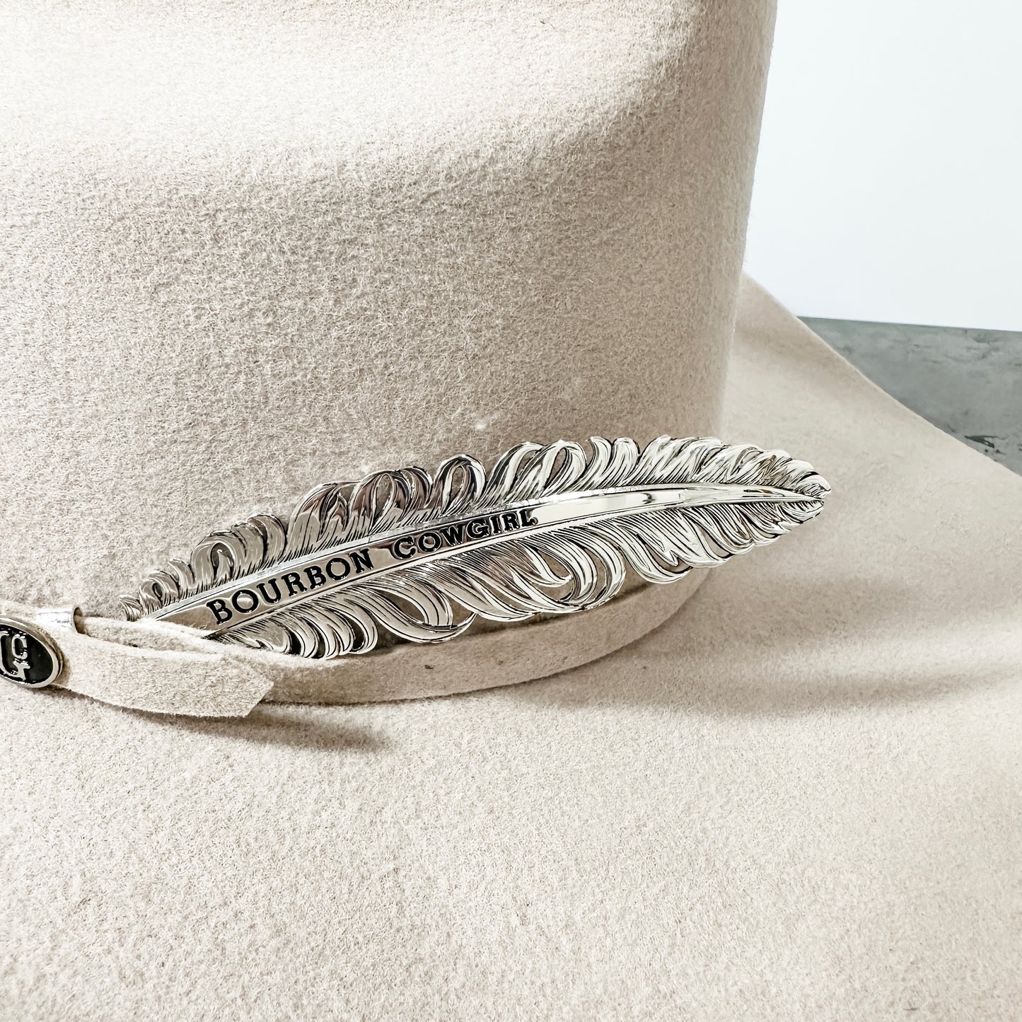 Cowboy hat with feather detail.