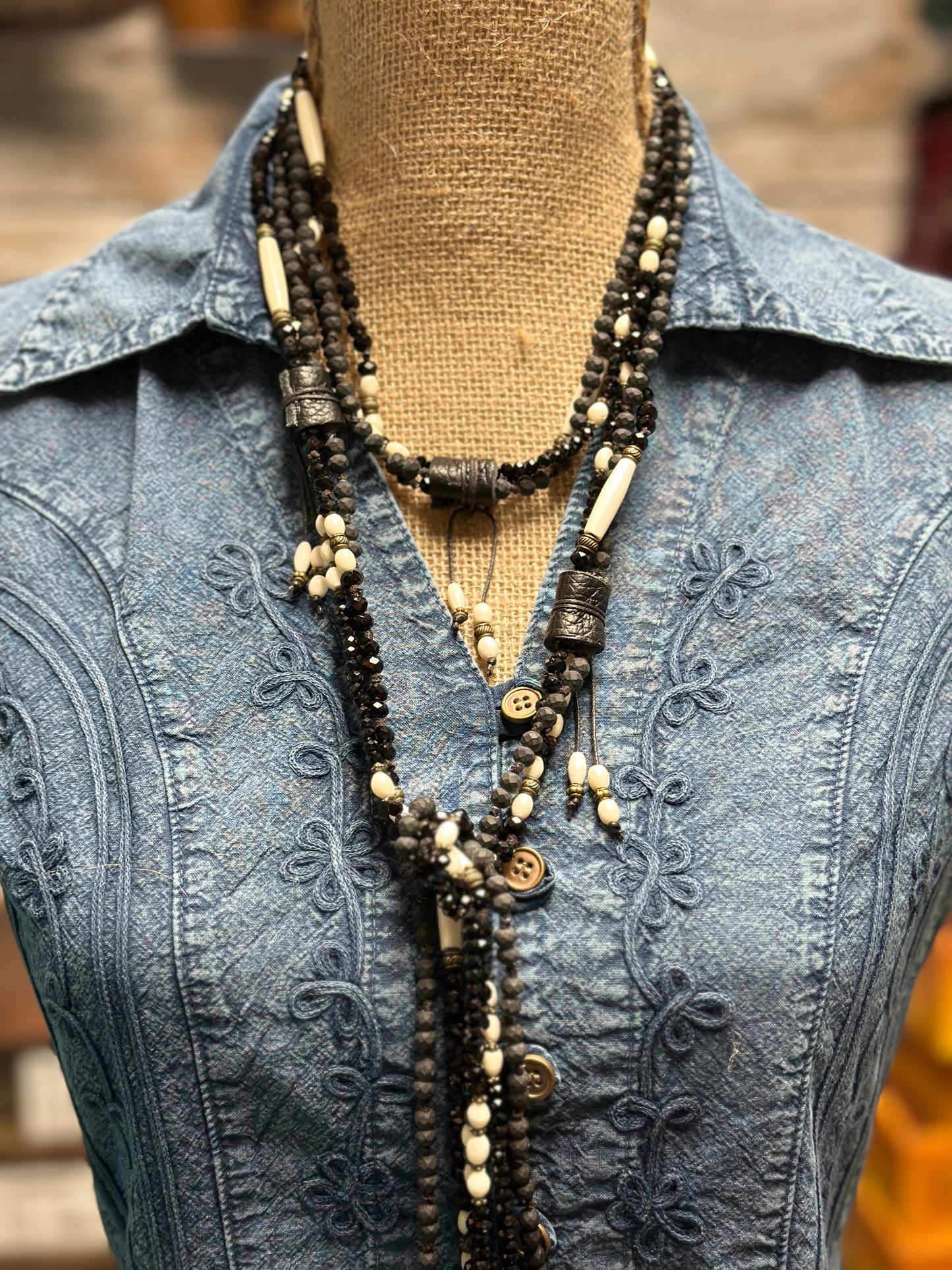 Necklace on denim shirt.