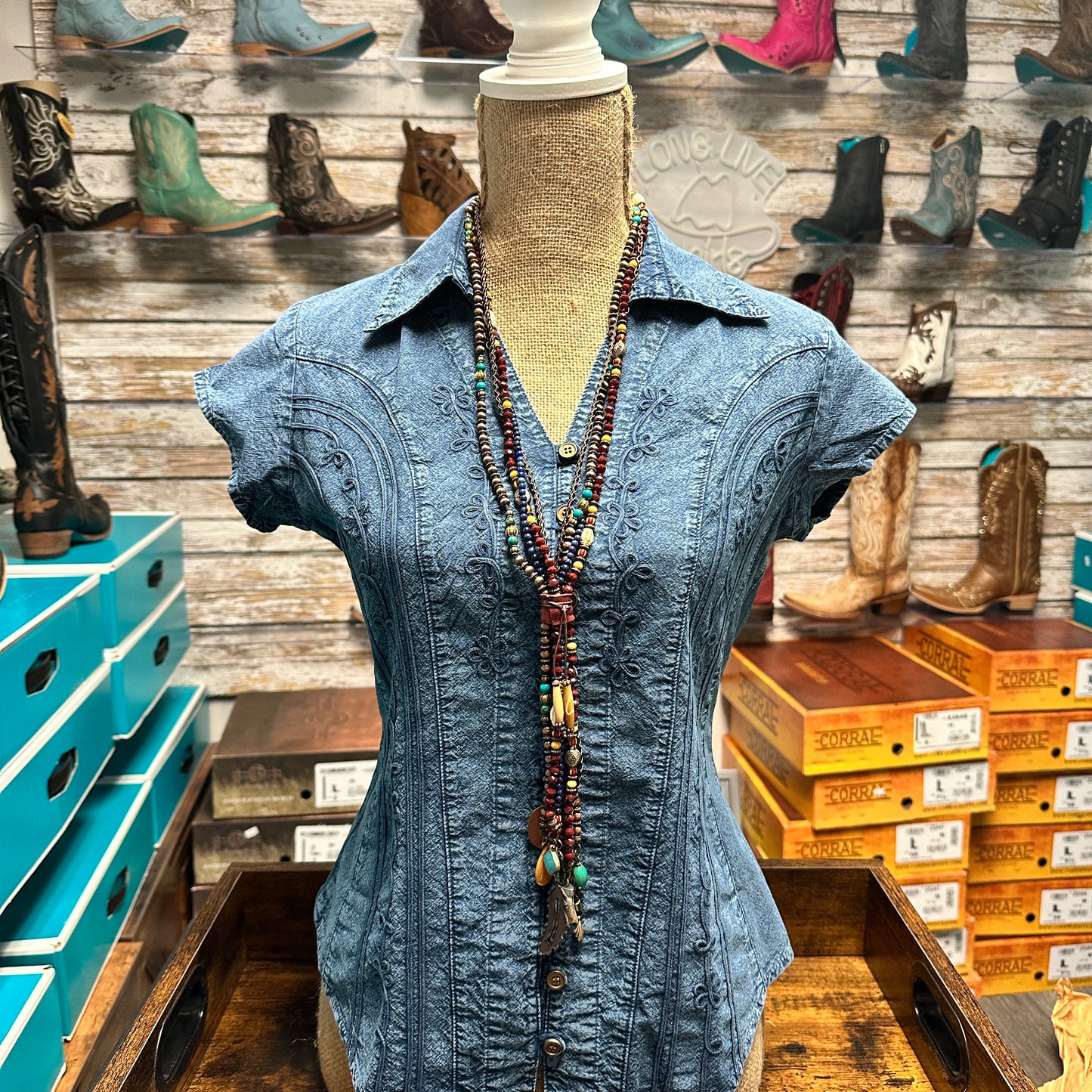Blue embroidered shirt and necklace on mannequin, IMG_71952