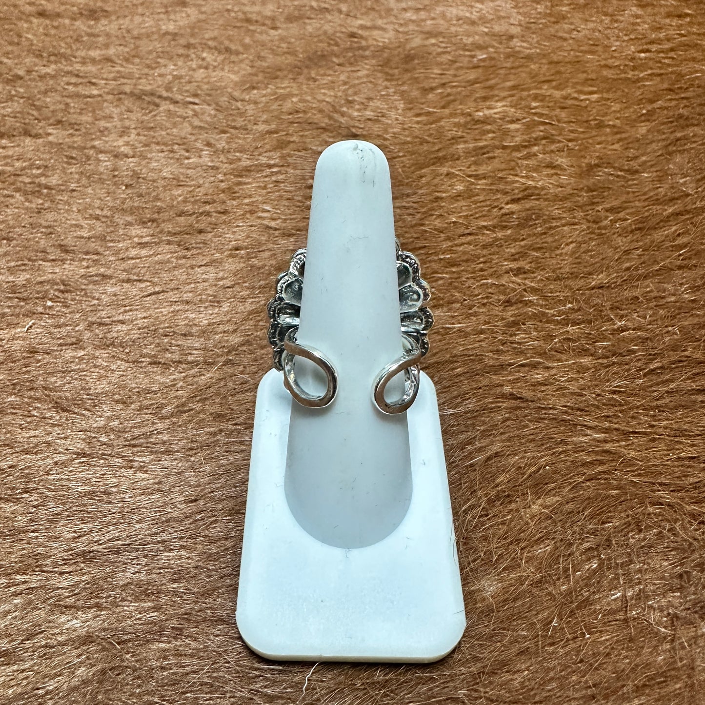 Ring on a white display stand.