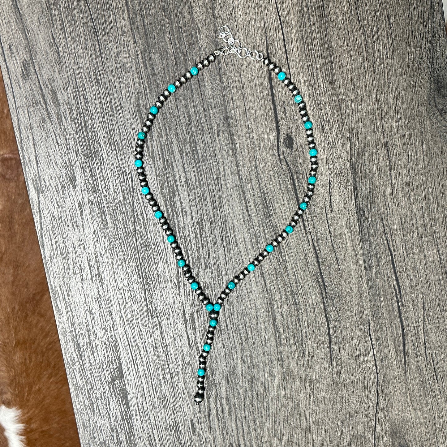 Turquoise and silver beaded lariat necklace.
